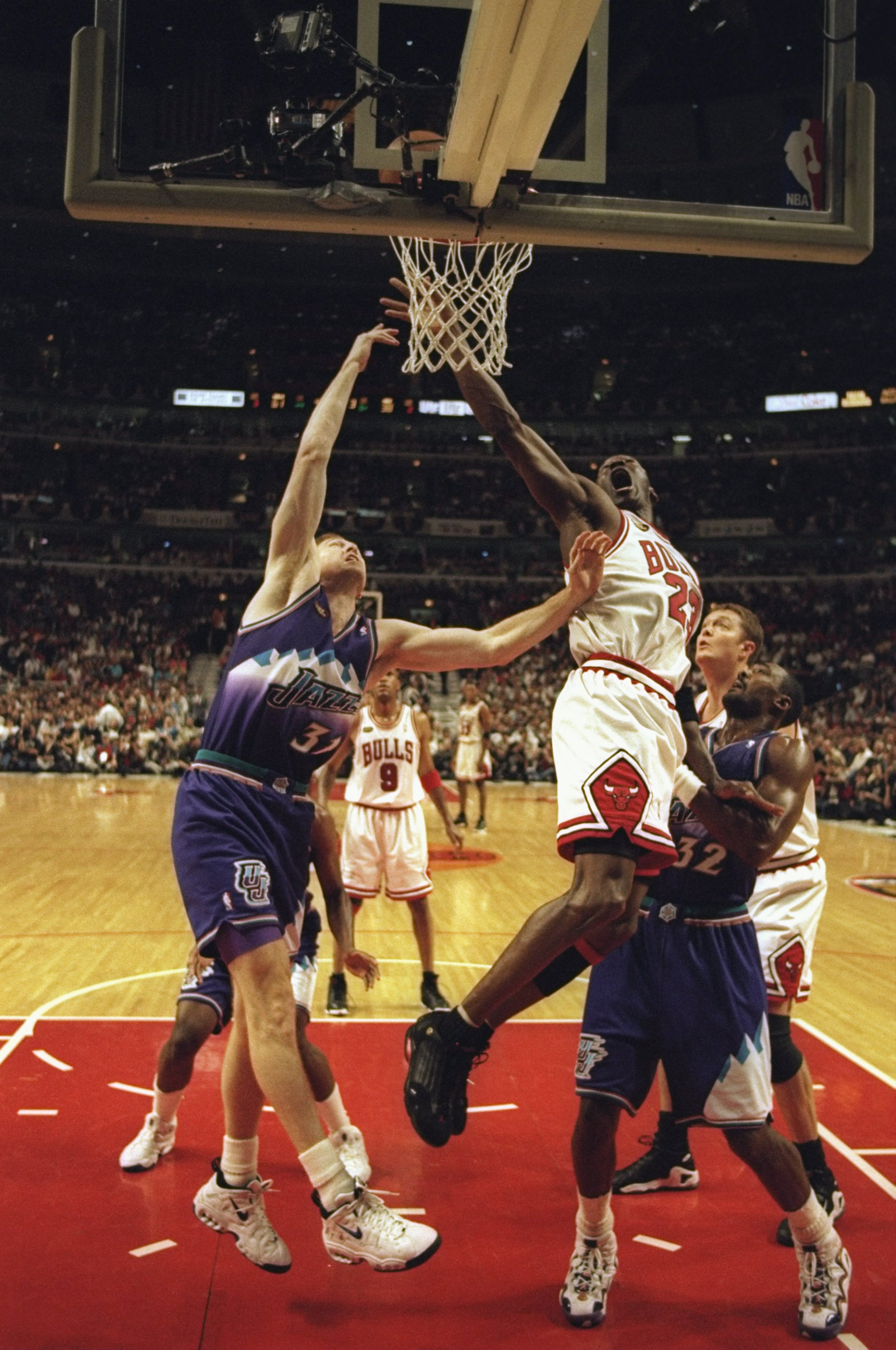 7 Jun 1998:  Michael Jordan #23 of the Chicago Bulls goes up for a shot as Adam Keefe #31 and Karl Malone #32 of the Utah Jazz try to stop him during the NBA Finals game 3 at the United Center in Chicago, Illinois.  The Bulls defeated the Jazz 96-54. Mand