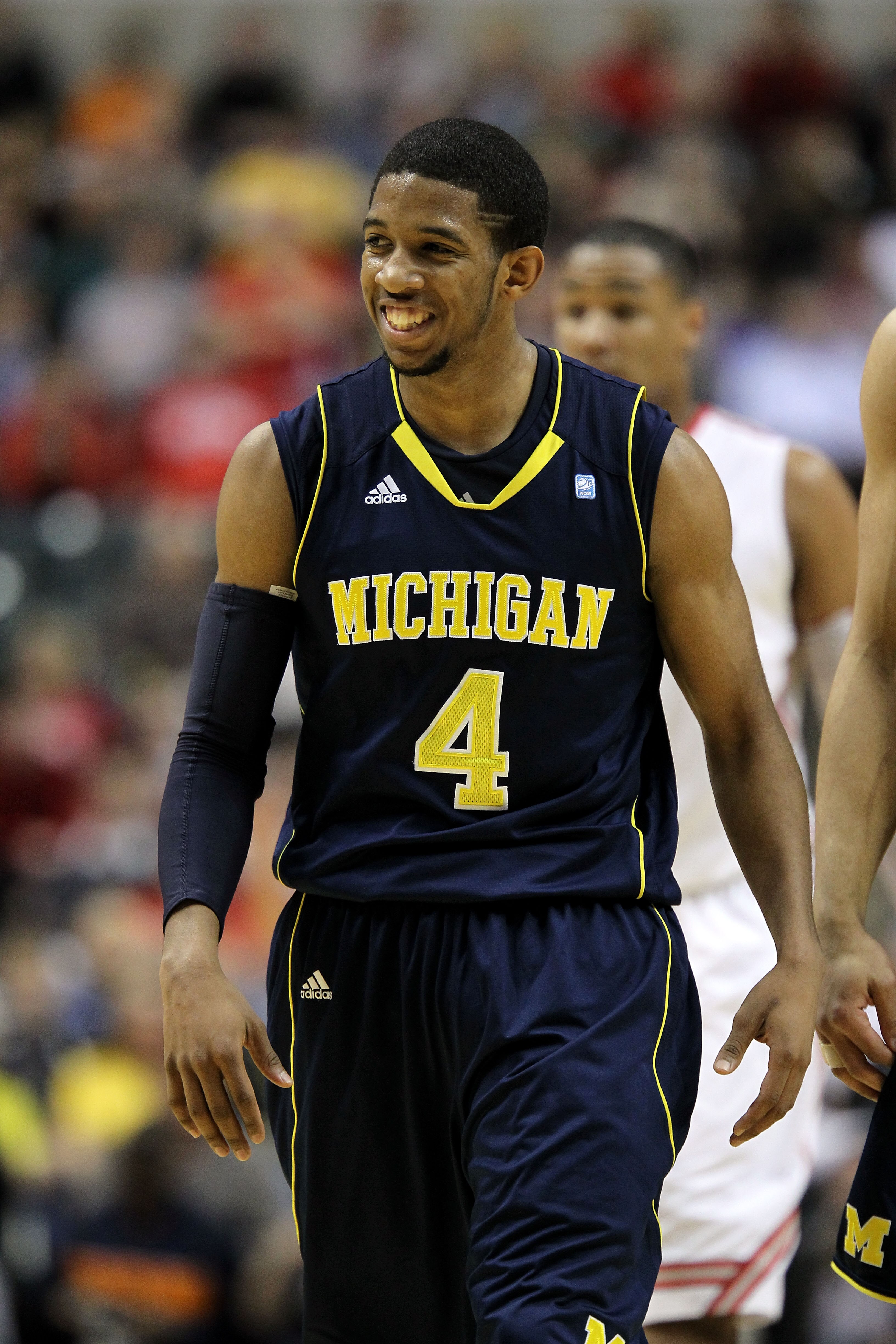 INDIANAPOLIS, IN - MARCH 12:  Darius Morris #4 of the Michigan Wolverines smiles as he looks on against the Ohio State Buckeyes during the semifinals of the 2011 Big Ten Men's Basketball Tournament at Conseco Fieldhouse on March 12, 2011 in Indianapolis,