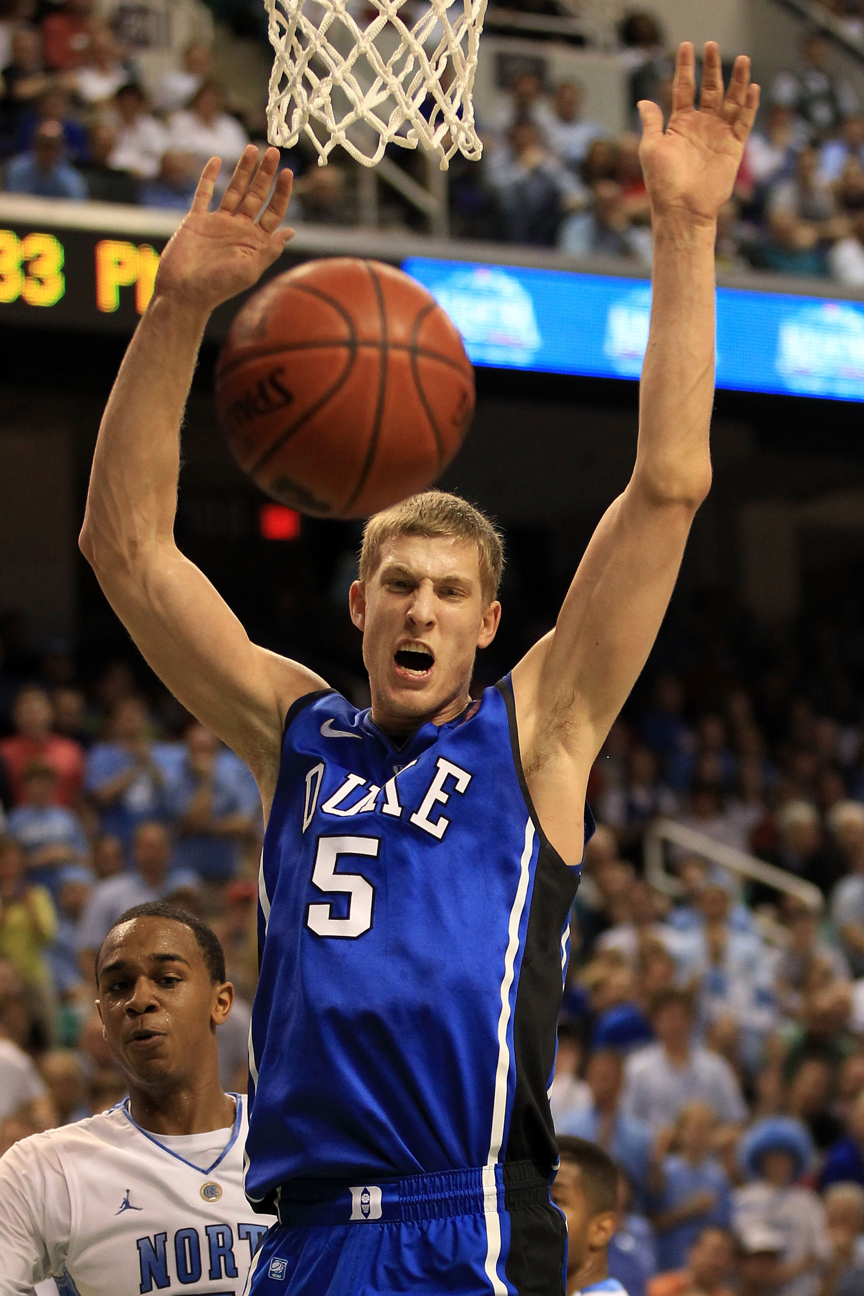 GREENSBORO, NC - MARCH 13:  Mason Plumlee #5 of the Duke Blue Devils celebrates his dunk against John Henson #31 of the North Carolina Tar Heels during the first half in the championship game of the 2011 ACC men's basketball tournament at the Greensboro C