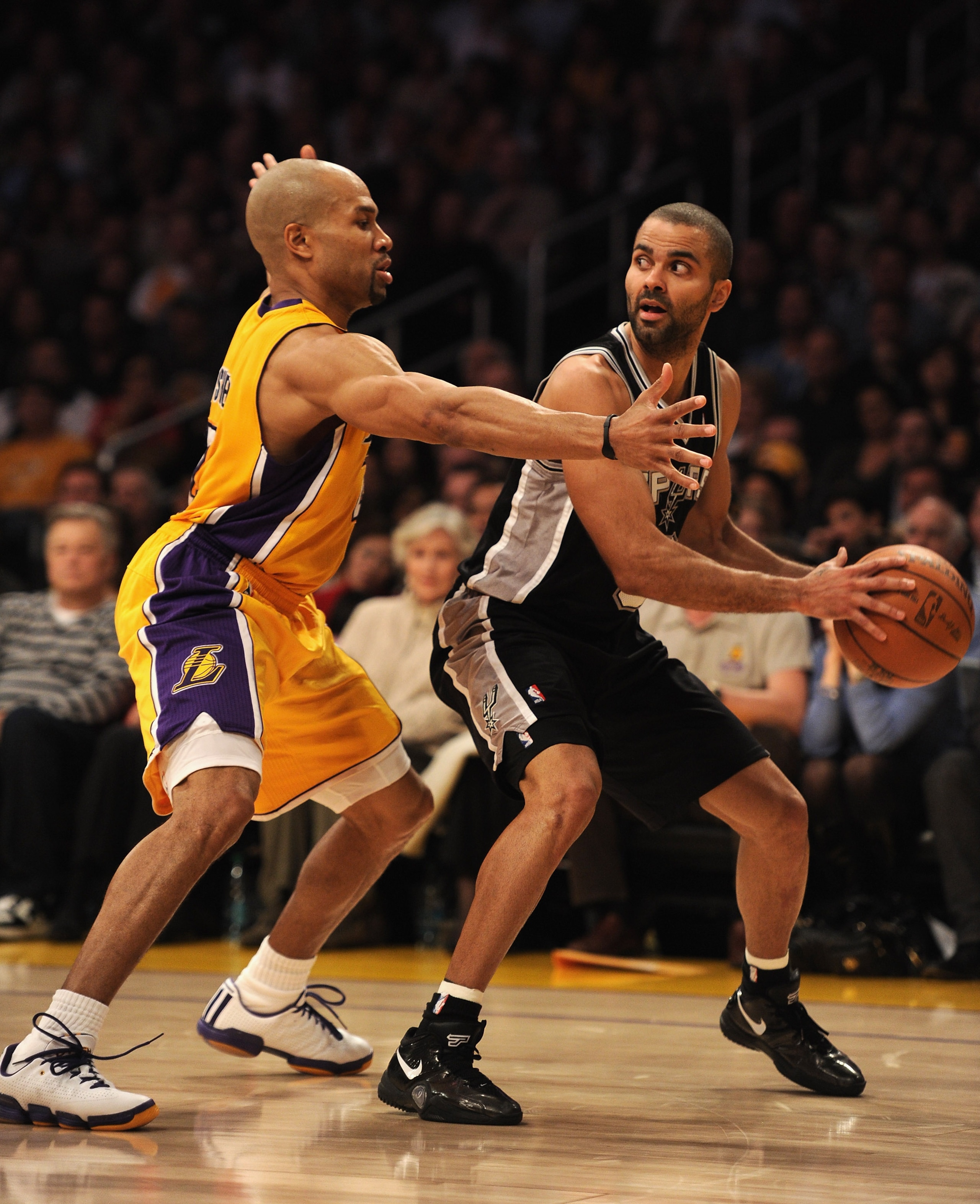 LOS ANGELES, CA - FEBRUARY 03:  Tony Parker #9 of the San Antonio Spurs is guarded by Derek Fisher #2 of the Los Angeles Lakers at Staples Center on February 3, 2011 in Los Angeles, California.  NOTE TO USER: User expressly acknowledges and agrees that, b