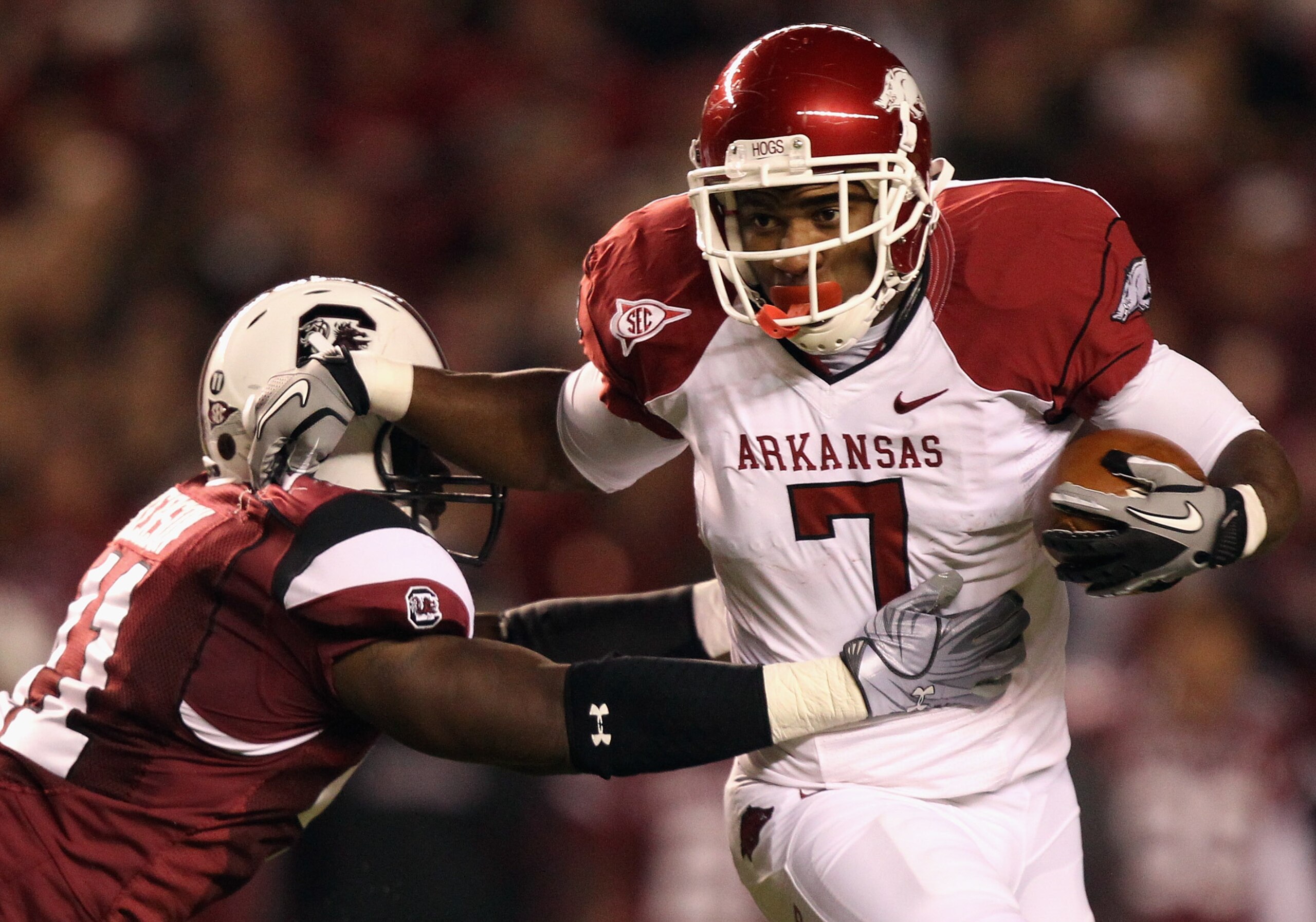 COLUMBIA, SC - NOVEMBER 06:  Knile Davis #7 of the Arkansas Razorbacks pushes away from Josh Dickerson #41 of the South Carolina Gamecocks during their game at Williams-Brice Stadium on November 6, 2010 in Columbia, South Carolina.  (Photo by Streeter Lec