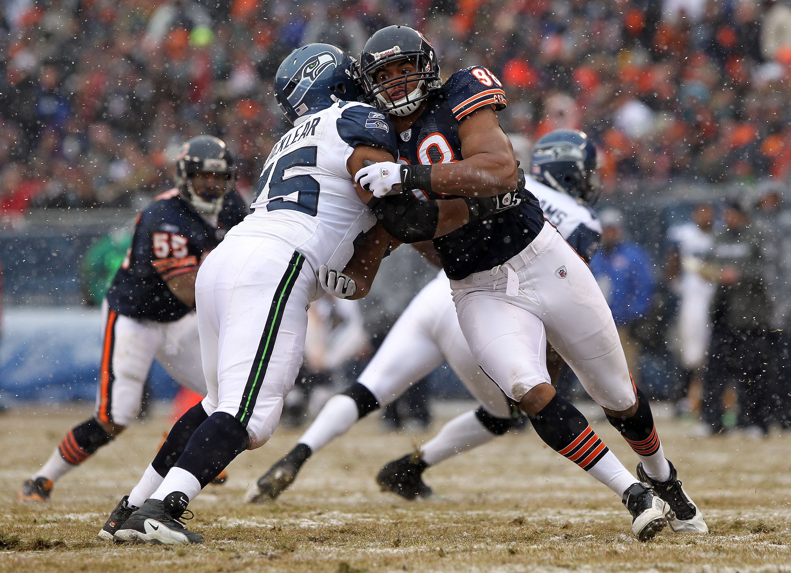 CHICAGO, IL - JANUARY 16:  Julius Peppers #90 of the Chicago Bears is blocked by Chris Spencer #65 of the Seattle Seahawks in the 2011 NFC divisional playoff game at Soldier Field on January 16, 2011 in Chicago, Illinois.  (Photo by Doug Pensinger/Getty I