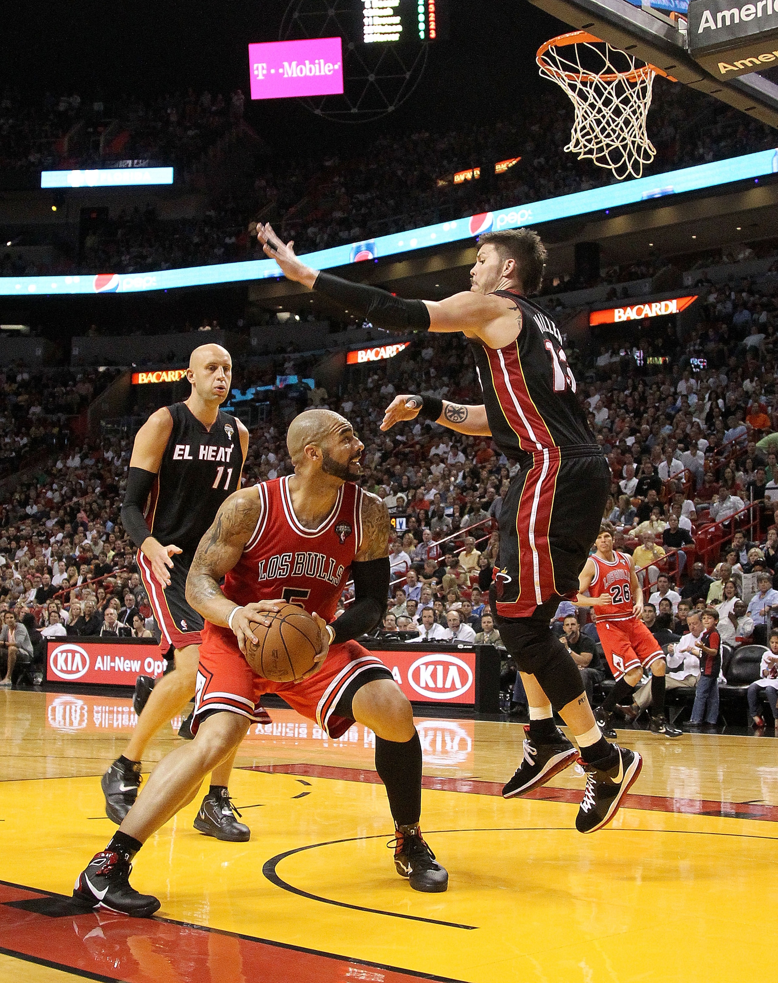 MIAMI, FL - MARCH 06:  Carlos Boozer #5 of  the Chicago Bulls posts up Mike Miller #13 of the Miami Heat during a game at American Airlines Arena on March 6, 2011 in Miami, Florida. NOTE TO USER: User expressly acknowledges and agrees that, by downloading