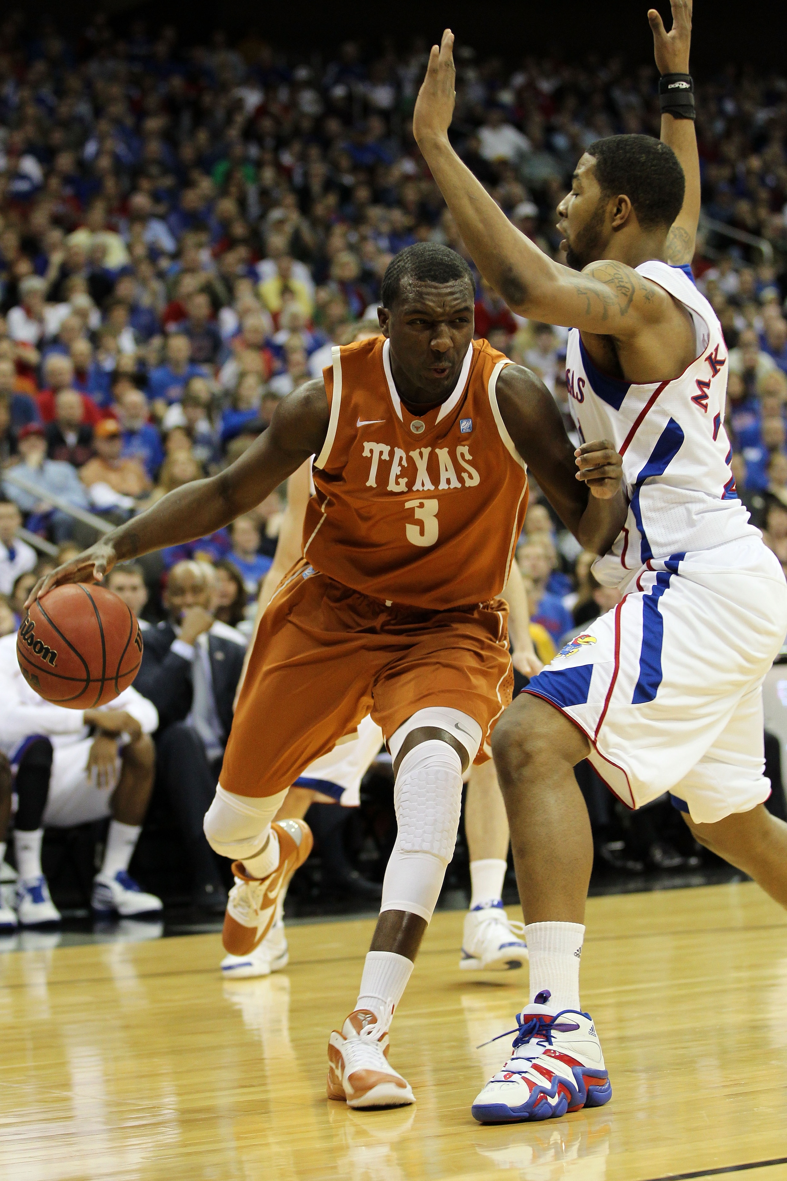KANSAS CITY, MO - MARCH 12:  Jordan Hamilton #3 of the Texas Longhorns drives with the ball against Markieff Morris #21 of the Kansas Jayhawks in the first half of the 2011 Phillips 66 Big 12 Men's Basketball Tournament championship game at Sprint Center