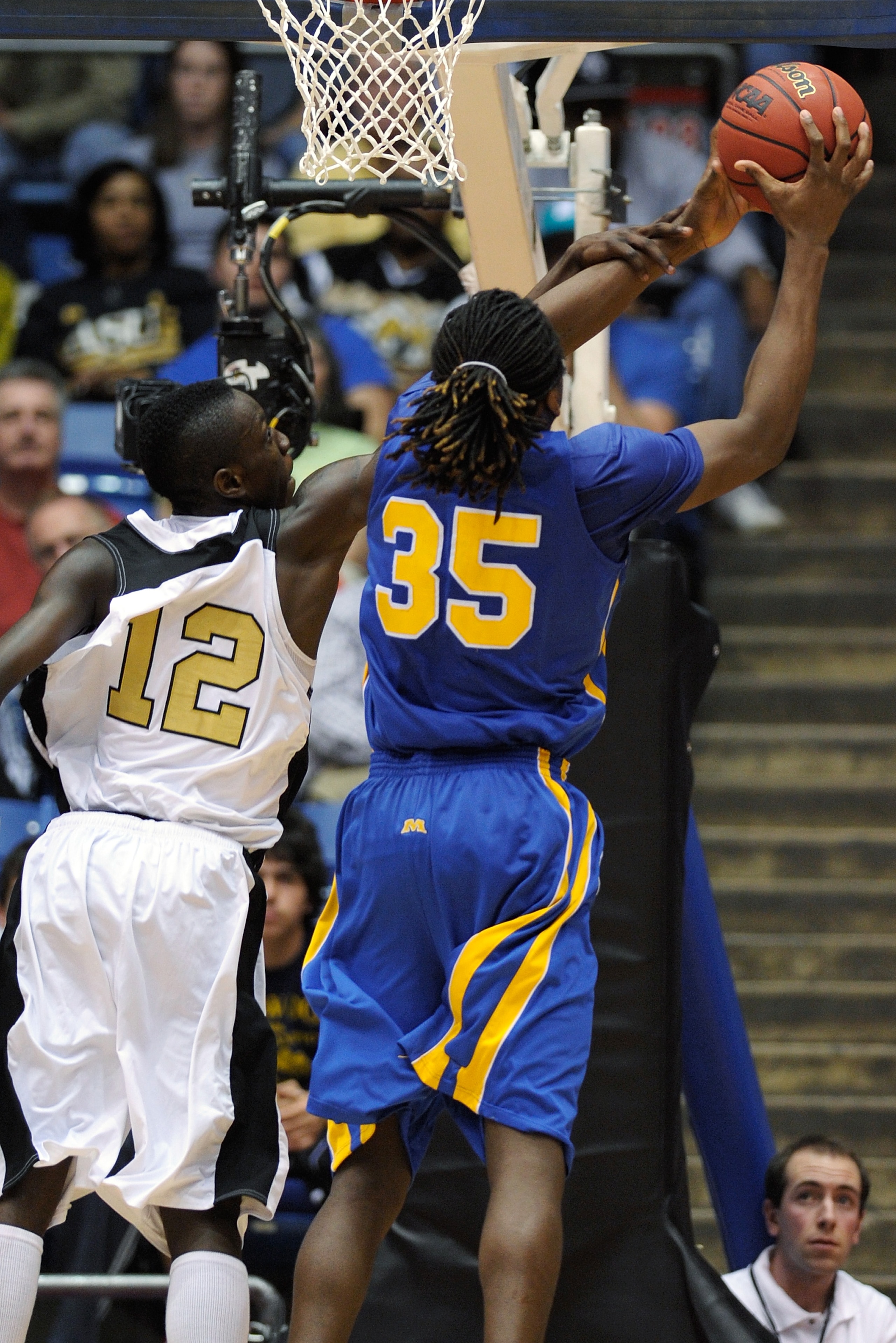 DAYTON, OH - MARCH 17: Ivory White #12 of the Alabama State Hornets fouls Kenneth Faried #35 of the Morehead State Eagles during the opening round of the Men's NCAA Tournament on March 17, 2009 at the University of Dayton Arena in Dayton, Ohio.  (Photo by