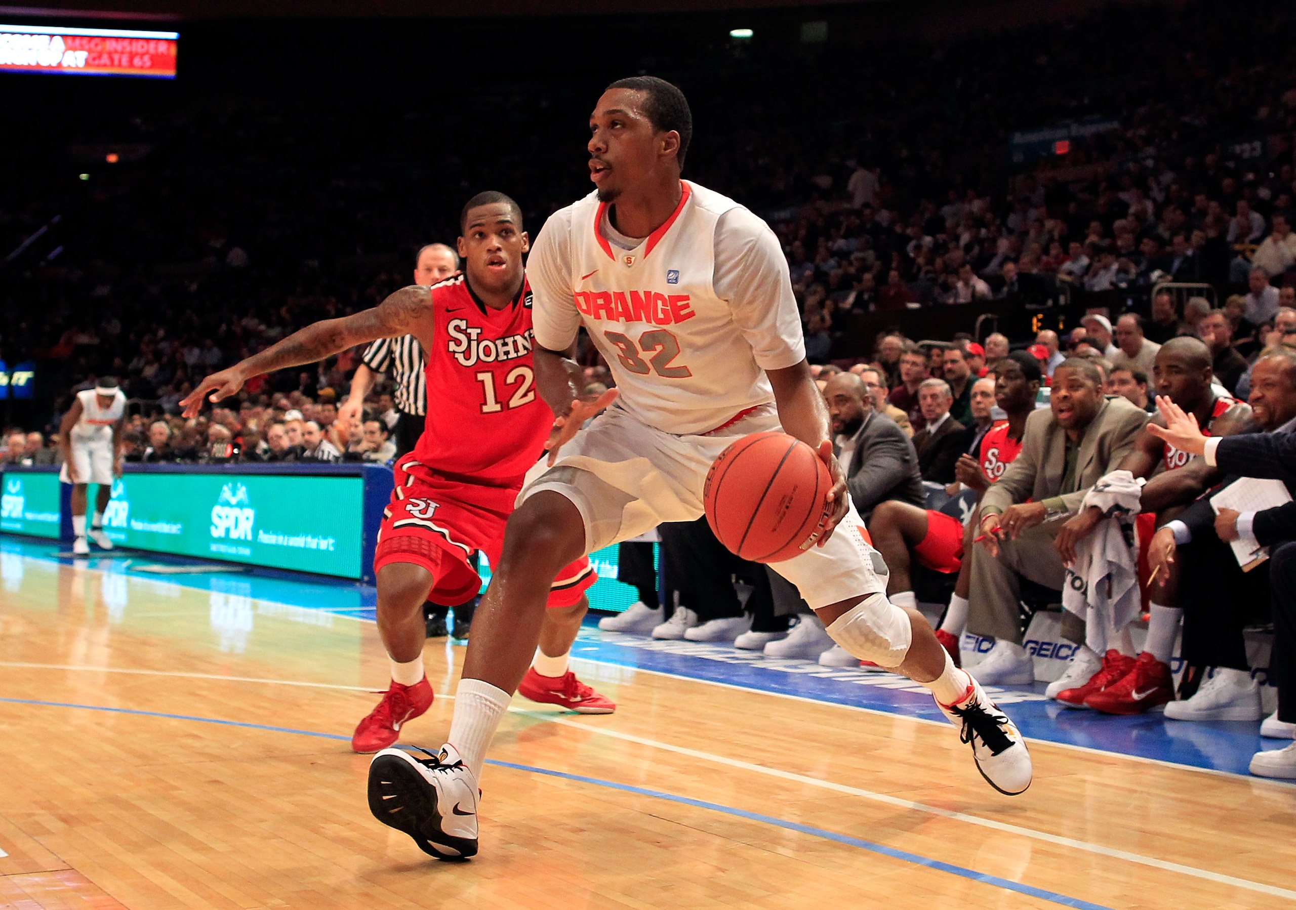 NEW YORK, NY - MARCH 10: Kris Joseph #32 of the Syracuse Orange dribbles past Dwight Hardy #12 of the St. John's Red Storm during the quarterfinals of the 2011 Big East Men's Basketball Tournament presented by American Eagle Outfitters  at Madison Square