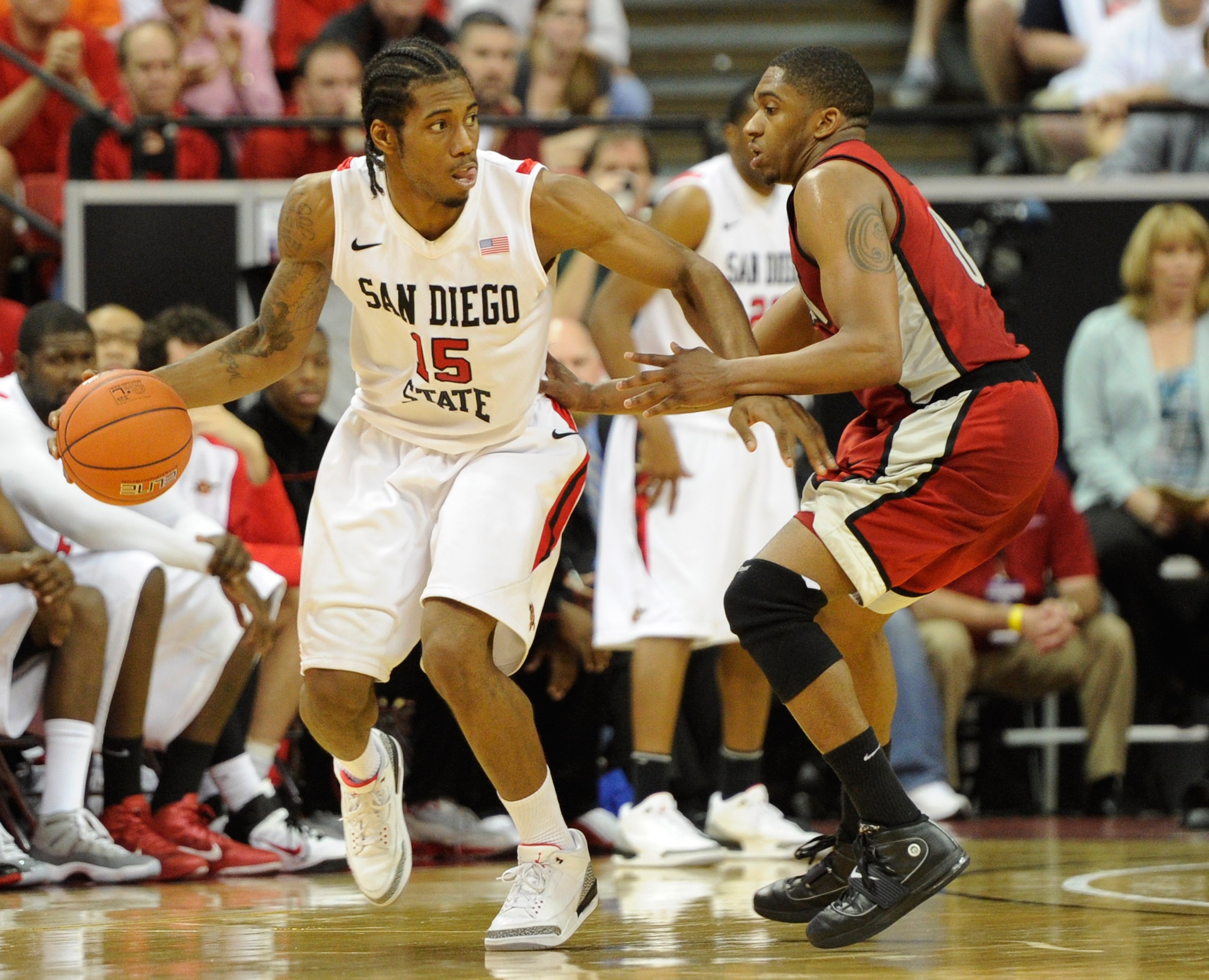 LAS VEGAS, NV - MARCH 11:  Kawhi Leonard #15 of the San Diego State Aztecs is guarded by Oscar Bellfield #0 of the UNLV Rebels during a semifinal game of the Conoco Mountain West Conference Basketball tournament at the Thomas & Mack Center March 11, 2011
