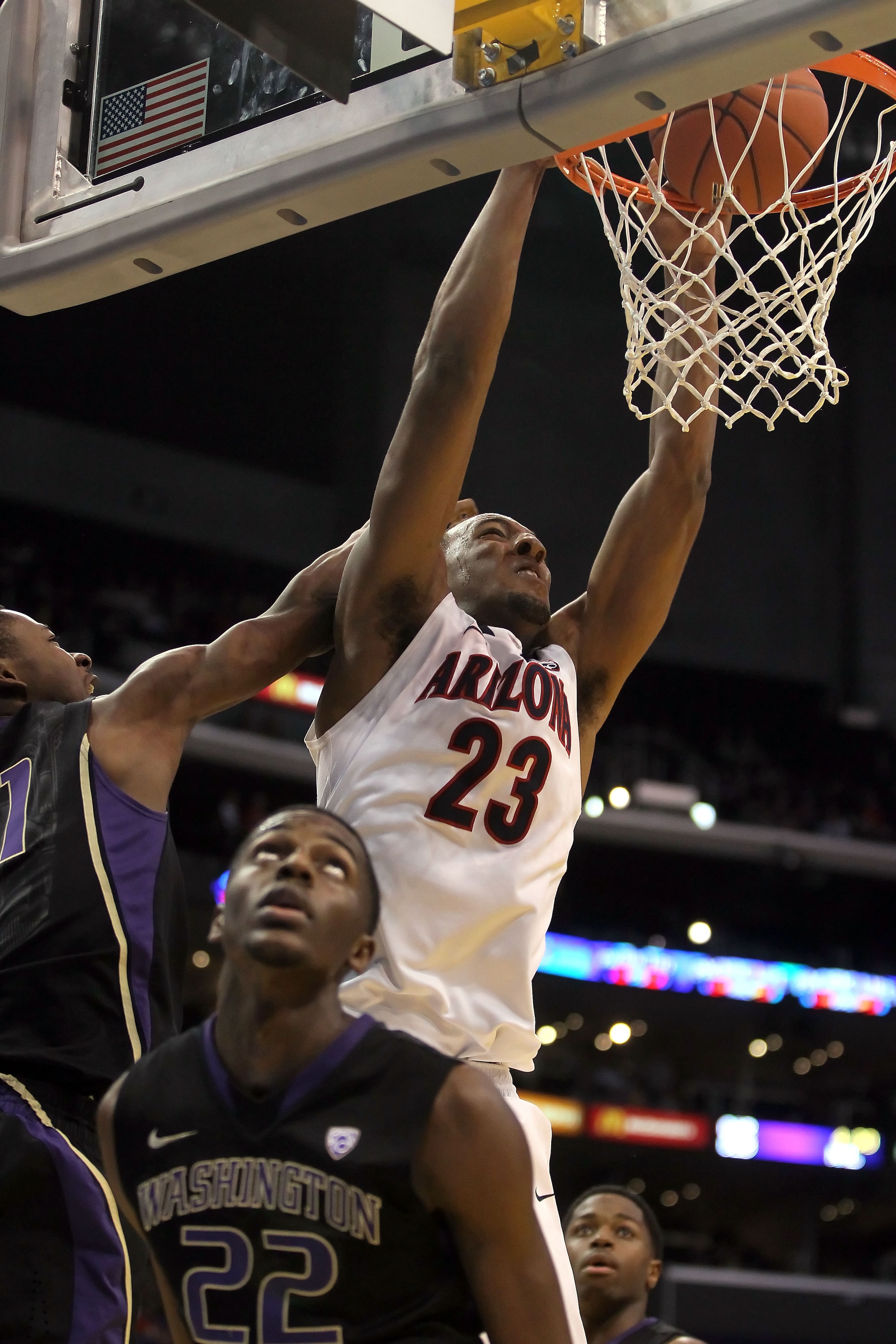 LOS ANGELES, CA - MARCH 12:  Derrick Williams #23 of the Arizona Wildcats dunks the ball between Terrence Ross #31 and Justin Holiday #22 of the Washington Huskies in the first half in the championship game of the 2011 Pacific Life Pac-10 Men's Basketball