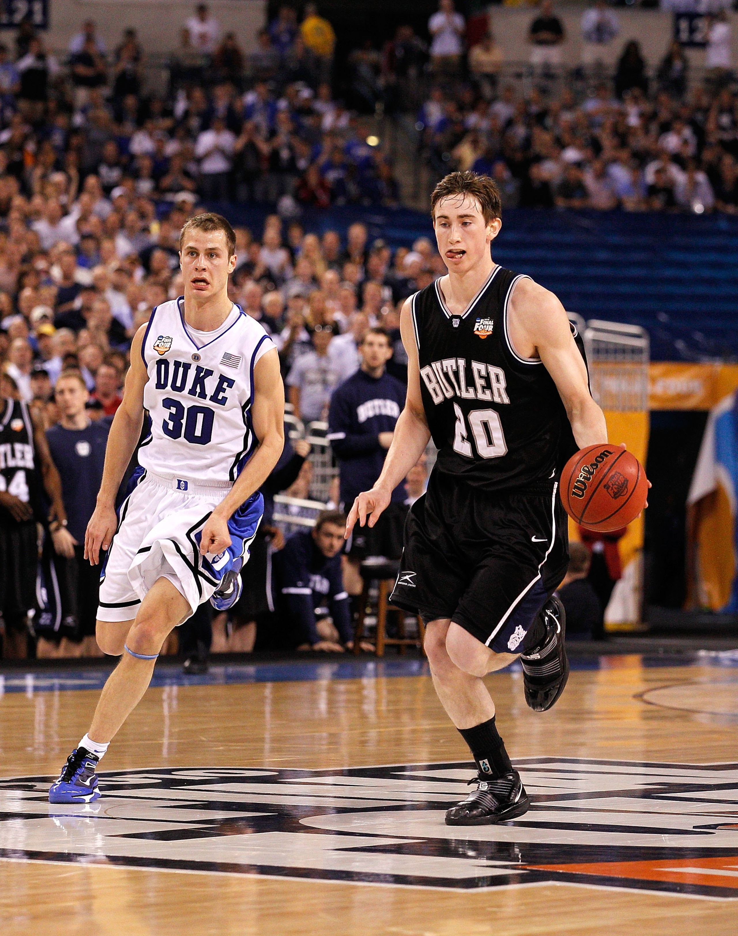 INDIANAPOLIS - APRIL 05:  Gordon Hayward #20 of the Butler Bulldogs brings the ball up court against Jon Scheyer #30 of the Duke Blue Devils during the 2010 NCAA Division I Men's Basketball National Championship game at Lucas Oil Stadium on April 5, 2010