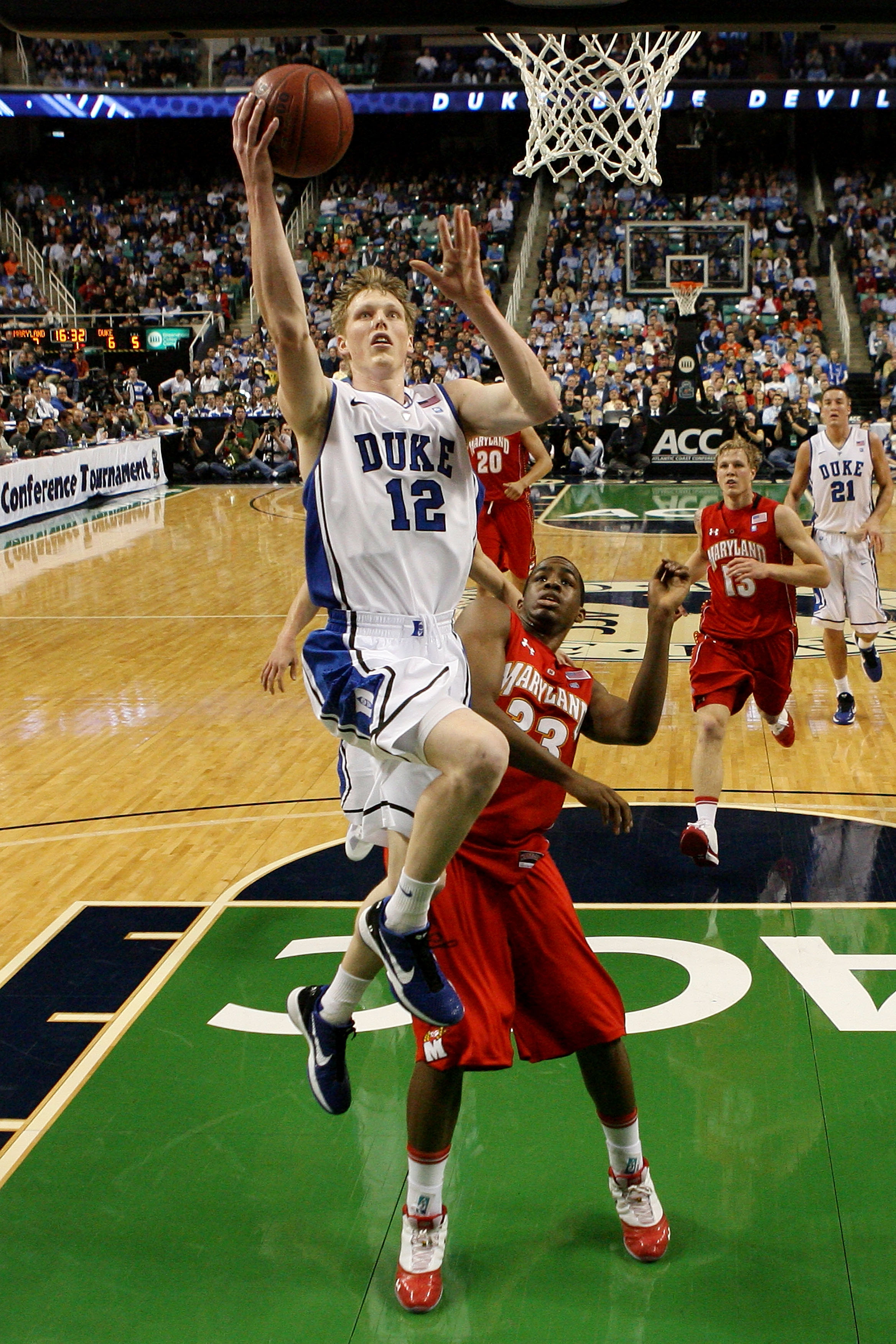 GREENSBORO, NC - MARCH 11: Kyle Singler #12 of the Duke Blue Devils shoots against Dino Gregory #33 of the Maryland Terrapins during the second half in the quarterfinals of the 2011 ACC men's basketball tournament at the Greensboro Coliseum on March 11,