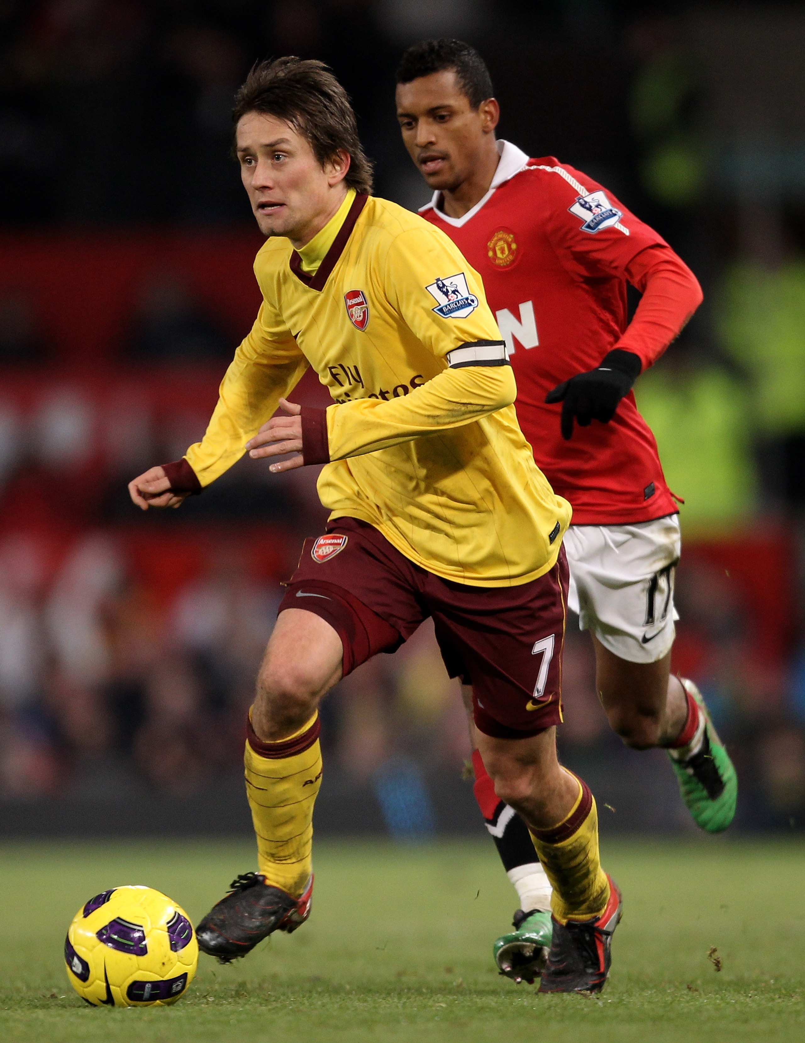MANCHESTER, UNITED KINGDOM - DECEMBER 13: Tomas Rosicky of Arsenal is pursued by Nani of Manchester United during the Barclays Premier League match between Manchester United and Arsenal at Old Trafford on December 13, 2010 in Manchester, England. (Photo MANCHESTER, UNITED KINGDOM - DECEMBER 13: Tomas Rosicky of Arsenal is pursued by Nani of Manchester United during the Barclays Premier League match between Manchester United and Arsenal at Old Trafford on December 13, 2010 in Manchester, England. (Photo