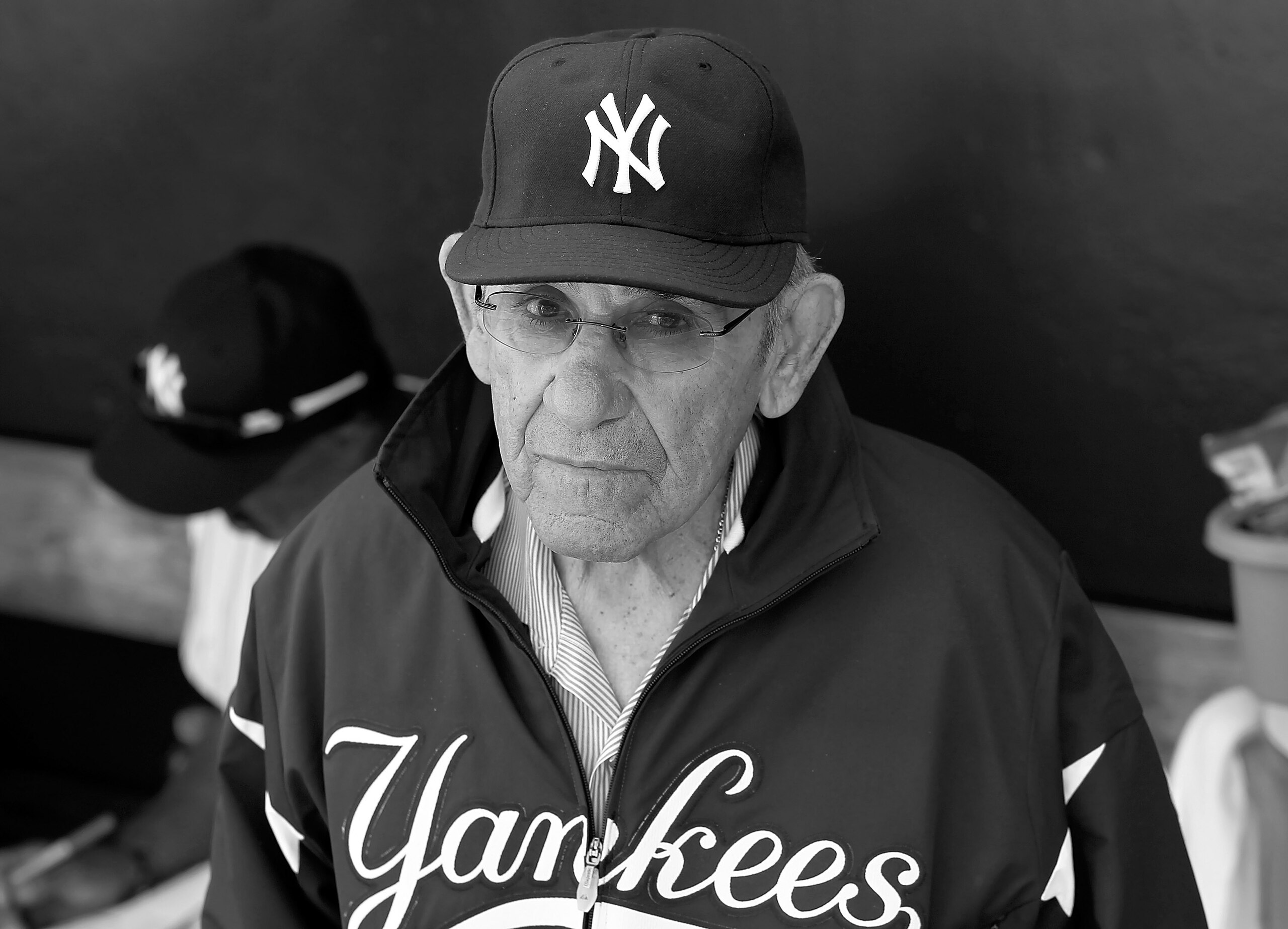 TAMPA, FL - FEBRUARY 26:  (EDITORS NOTE: Image has been converted to black and white.)  Hall of Famer Yogi Berra of the New York Yankees stands in the dugout just prior to the start of the Grapefruit League Spring Training Game against the Philadelphia Ph