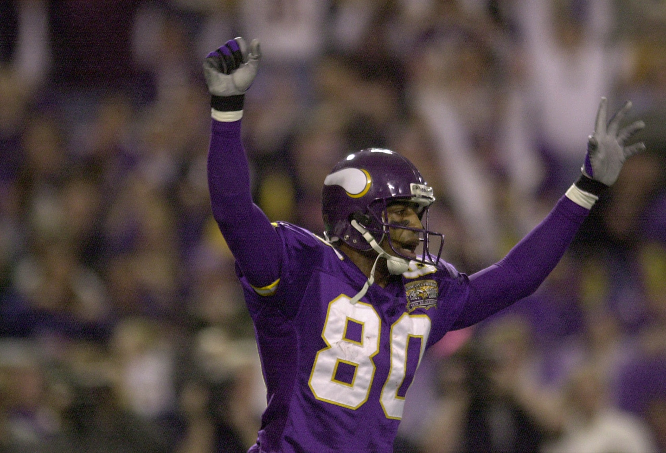 6 Jan 2001: Cris Carter #80 of the Minnesota Vikings celebrates teammate Robert Smith's touchdown against the New Orleans Saints at the Hubert H. Humphrey Metrodome in Minneapolis, Minnesota. The Minnesota Vikings beat the New Orleans Saints 34-16. DIGITA