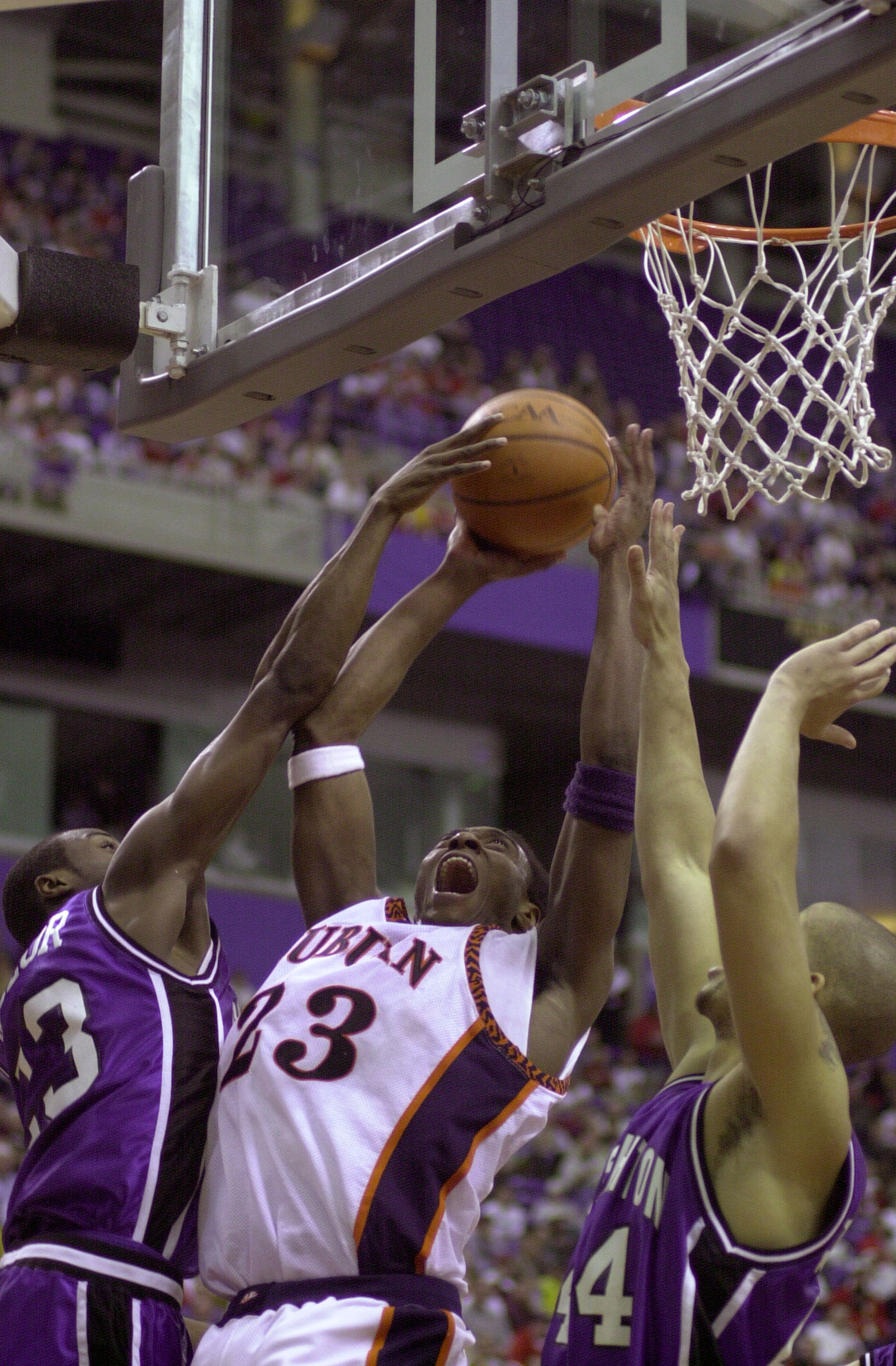 16 Mar 2000: Daymeon Fishback #23 of Auburn takes a shot as Terrell Taylor #23 and Donnie Johnson #44 of Creighton defend during the first round of NCAA regional action at the Hubert H. Humphrey Metrodome in Minneapolis, Minnesota. Auburn won 72-69. DIGIT