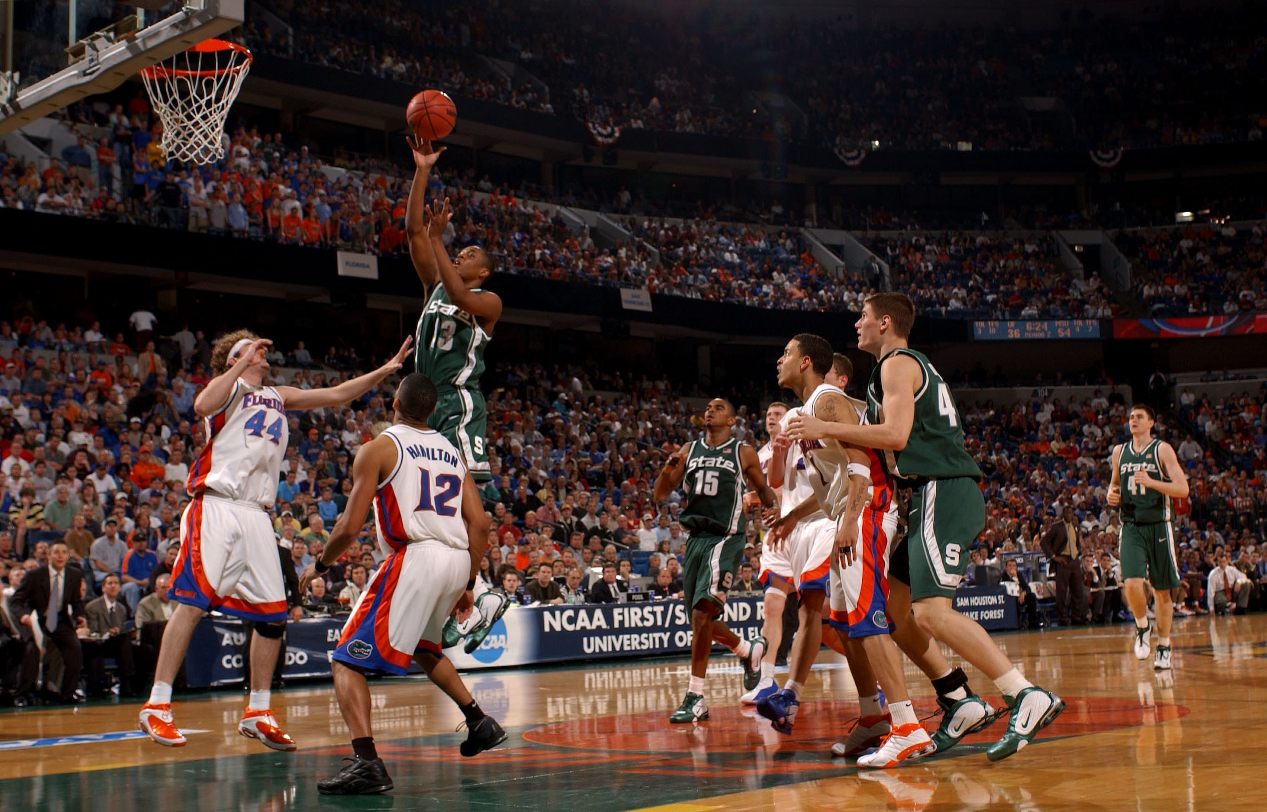 TAMPA, FL - MARCH 23:  Maurice Ager #13 of the Michigan State Spartans takes a shot over Matt Walsh #44 and Justin Hamilton #12 of the University of Florida Gators in the second round of the South Region of the 2003 NCAA Division I Men's Basketball Champi