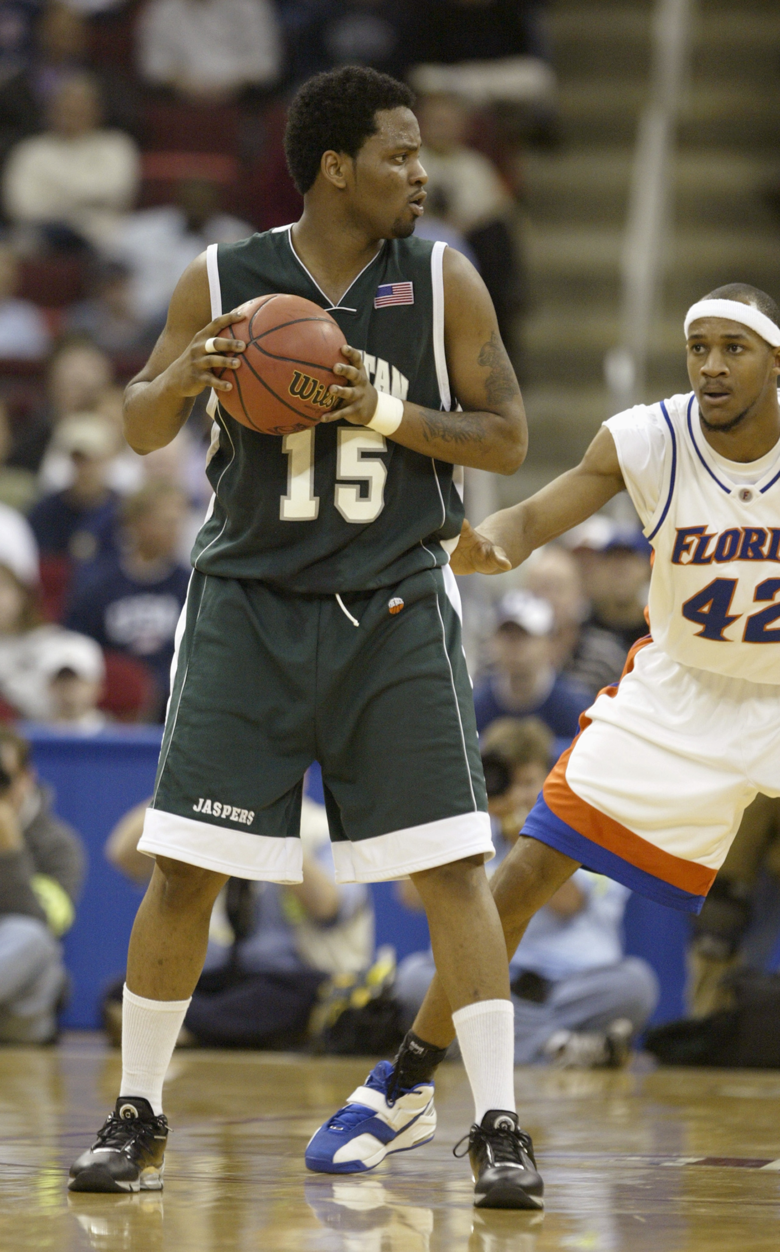 RALEIGH, NC - MARCH 18:  Dave Holmes #15 of the Manhattan Jaspers is covered by Bonell Coles #42 of the Florida Gators during the first round game of the NCAA Division I Men's Basketball Tournament at the RBC Center on March 18, 2004 in Raleigh, North Car