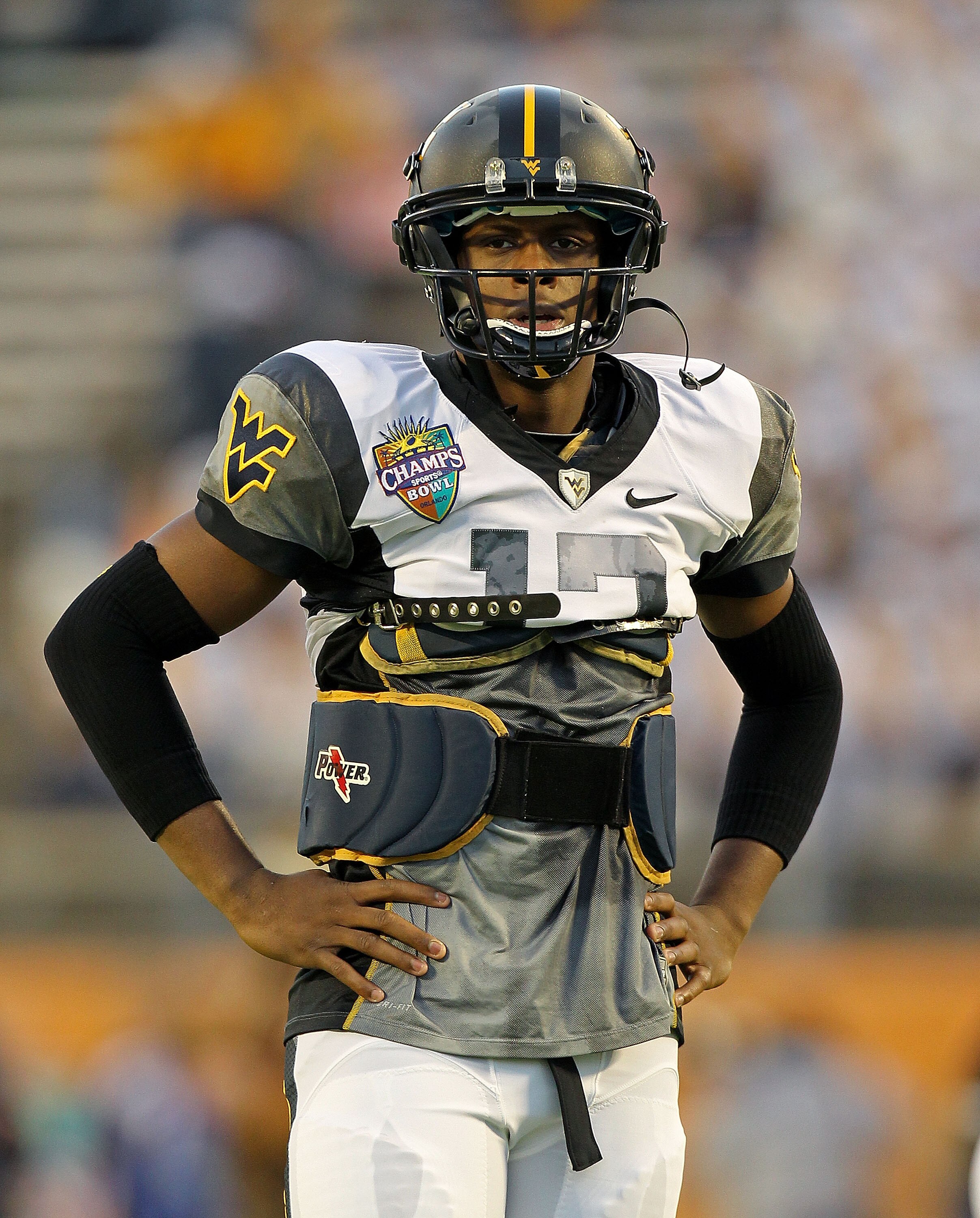 ORLANDO, FL - DECEMBER 28:  Geno Smith #12 of the West Virginia Mountineers warms up during the Champs Sports Bowl against the North Carolina State Wolfpack at Florida Citrus Bowl Stadium on December 28, 2010 in Orlando, Florida.  (Photo by Mike Ehrmann/G