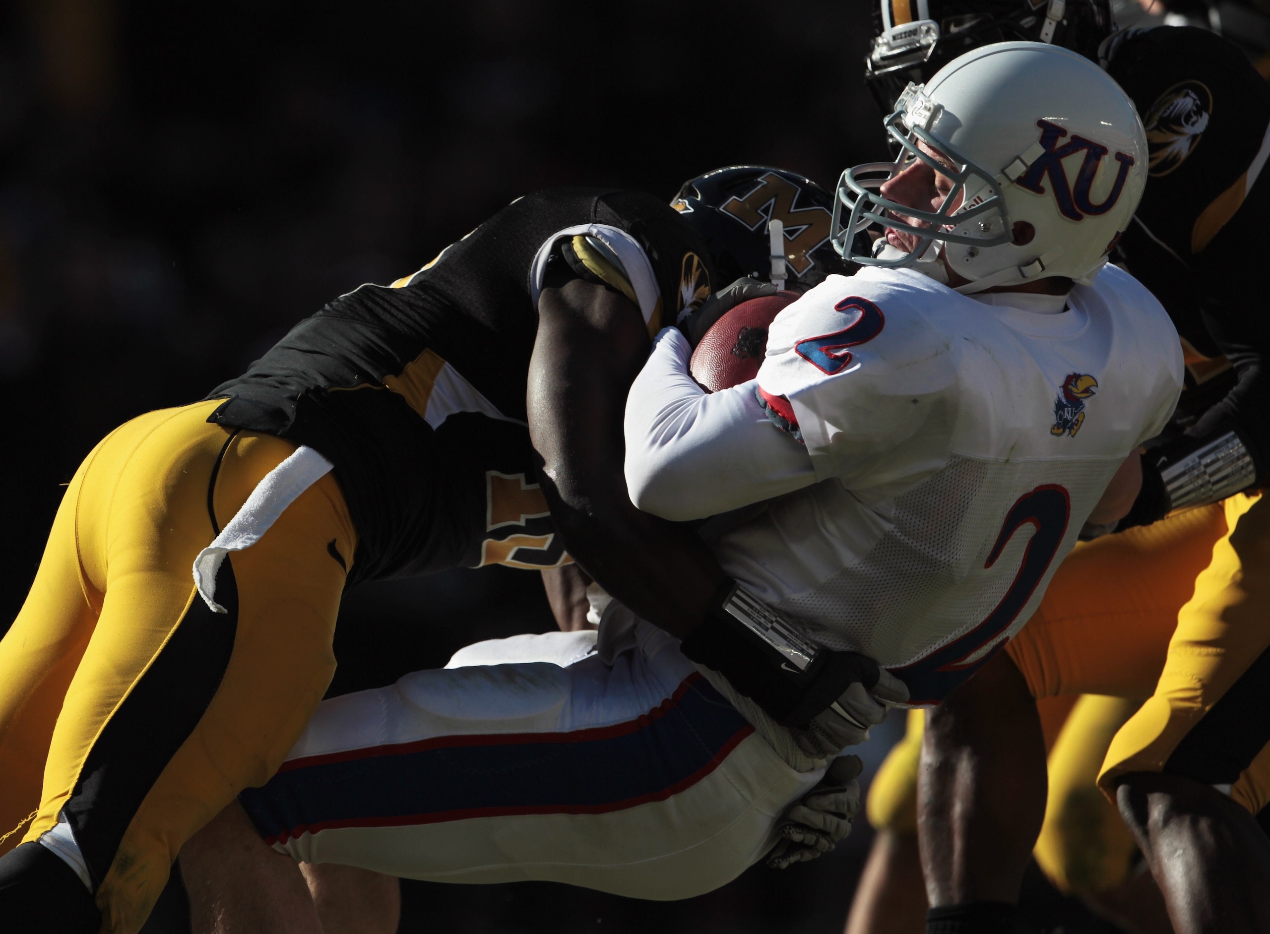 KANSAS CITY, MO - NOVEMBER 27: Quarterback Jordan Webb #2 of the Kansas Jayhawks carries the ball into the endzone for a touchdown as Kenji Jackson #13 of the Missouri Tigers defends on November 27, 2010 at Arrowhead Stadium in Kansas City, Missouri. (P KANSAS CITY, MO - NOVEMBER 27: Quarterback Jordan Webb #2 of the Kansas Jayhawks carries the ball into the endzone for a touchdown as Kenji Jackson #13 of the Missouri Tigers defends on November 27, 2010 at Arrowhead Stadium in Kansas City, Missouri. (P