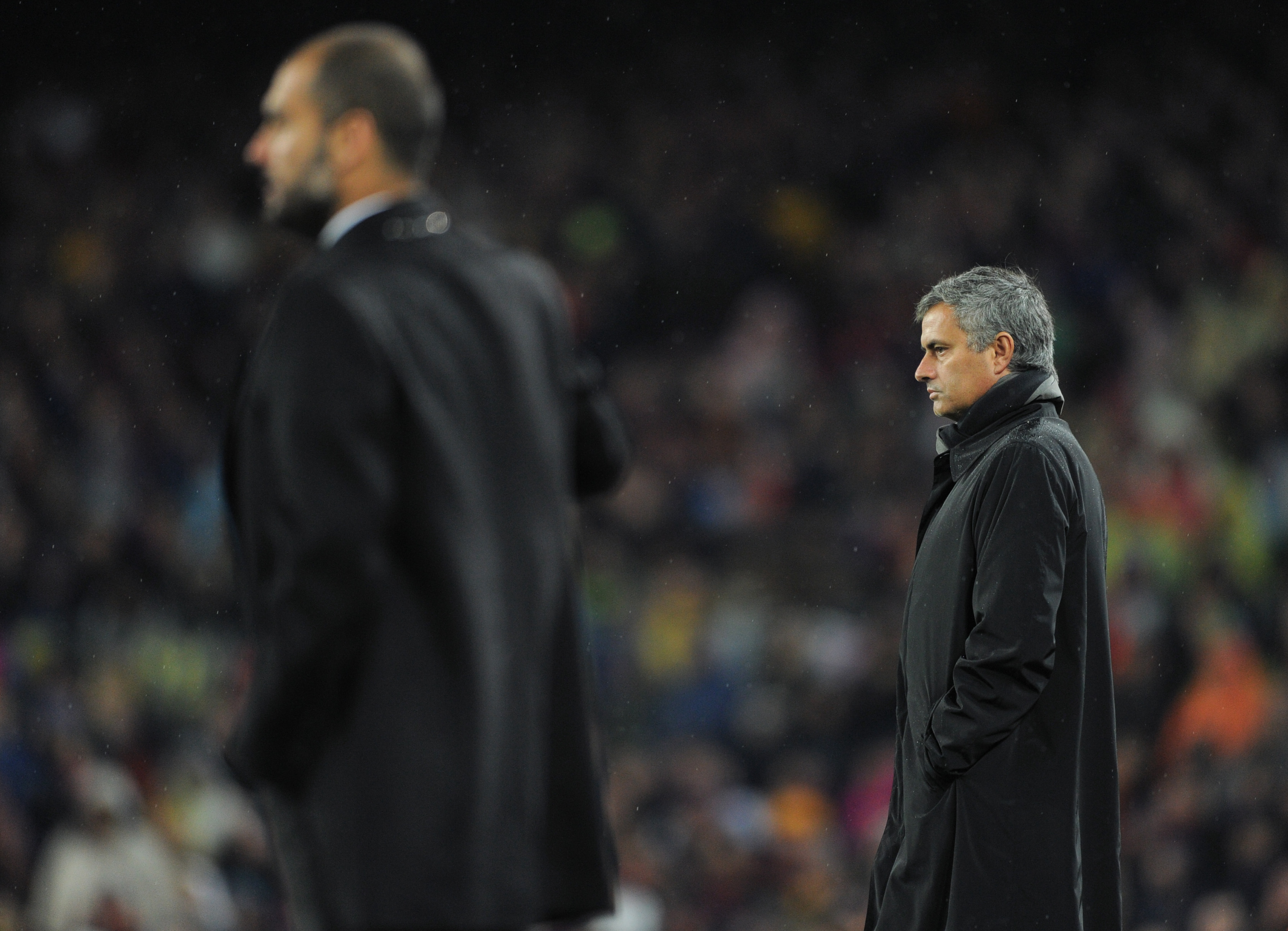 BARCELONA, SPAIN - NOVEMBER 29:  Head coach Jose Mourinho (R) of Real Madrid follows the game flanked by head coach Josep Guardiola of Barcelona during the la liga match between Barcelona and Real Madrid at the Camp Nou stadium on November 29, 2010 in Bar