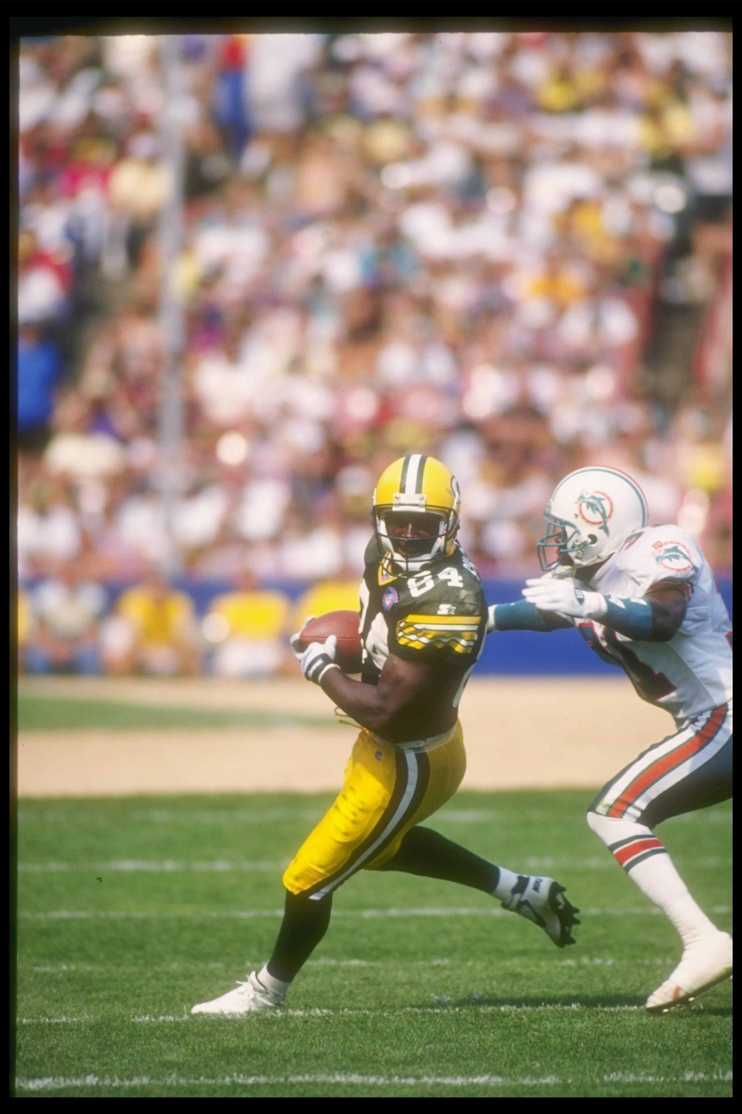 11 Sep 1994:  Wide receiver Sterling Sharpe of the Green Bay Packers  (left) moves the ball during a game against the Miami Dolphins at Milwaukee County Stadium in Milwaukee, Wisconsin.  The Dolphins won the game, 24-14. Mandatory Credit: Jonathan Daniel
