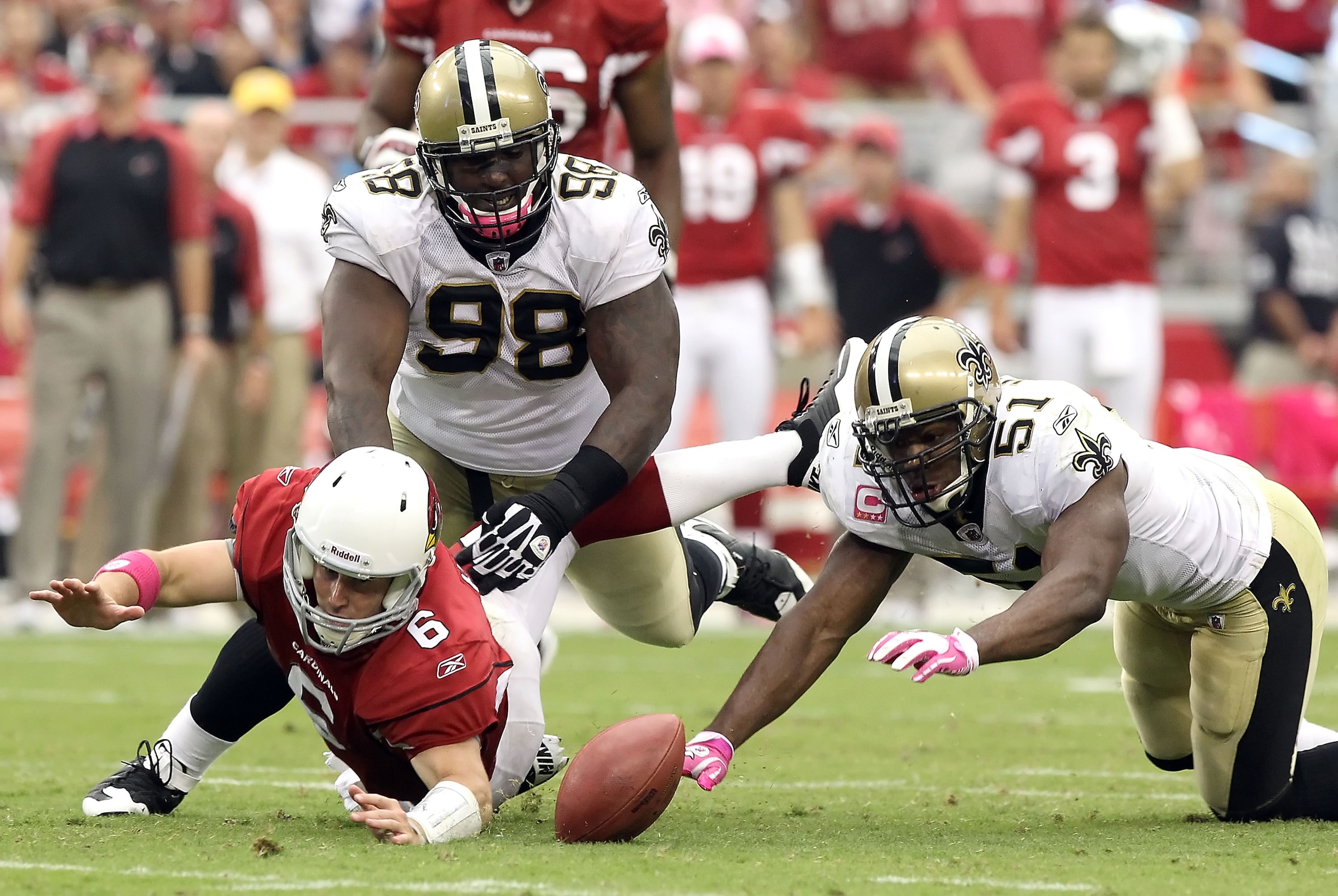 GLENDALE, AZ - OCTOBER 10:  Quarterback Max Hall #6 of the Arizona Cardinals fumbles the ball as Sedrick Ellis #98 and Jonathan Vilma #51 of the New Orleans Saints attempt to recover during the NFL game at the University of Phoenix Stadium on October 10,