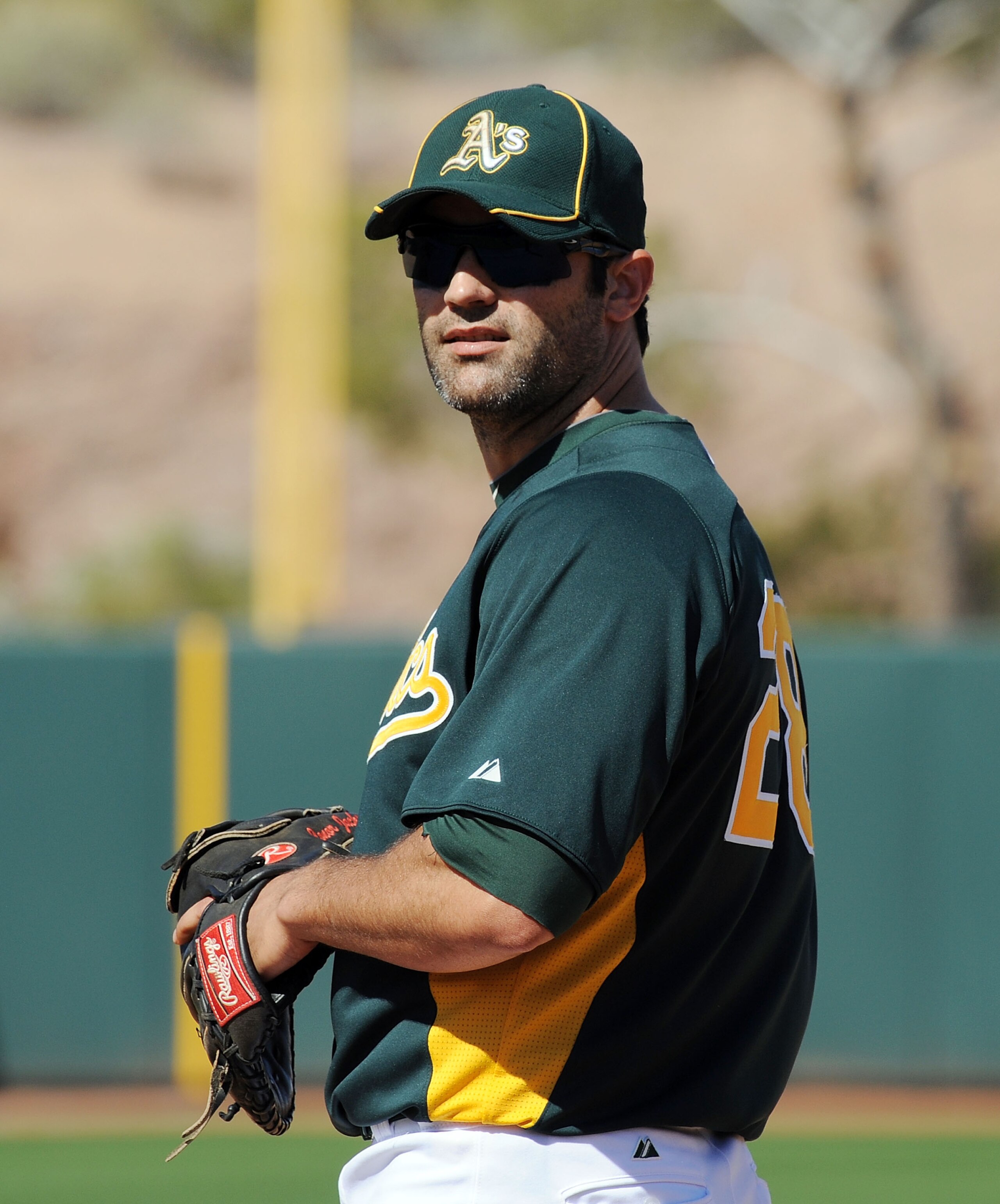 PHOENIX, AZ - MARCH 04:  Conor Jackson #28 of the Oakland Athletics gets ready to make a play against the Texas Rangers at Phoenix Municipal Stadium on March 4, 2011 in Phoenix, Arizona.  (Photo by Norm Hall/Getty Images)