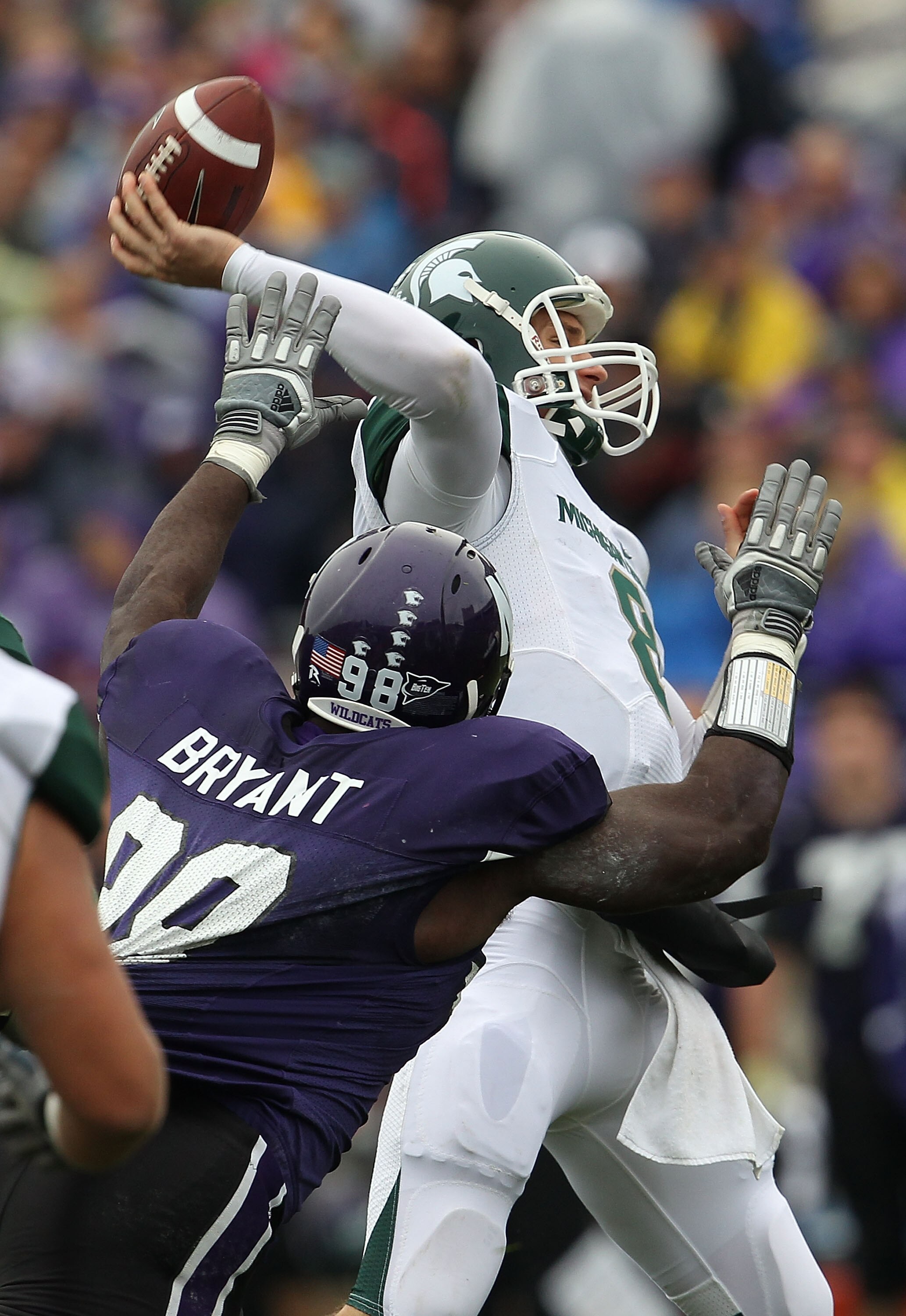 EVANSTON, IL - OCTOBER 23: Kirk Cousins #8 of the Michigan State Spartans throws a pass under pressure from Corbin Bryant #98 of the Northwestern Wildcats at Ryan Field on October 23, 2010 in Evanston, Illinois. (Photo by Jonathan Daniel/Getty Images)