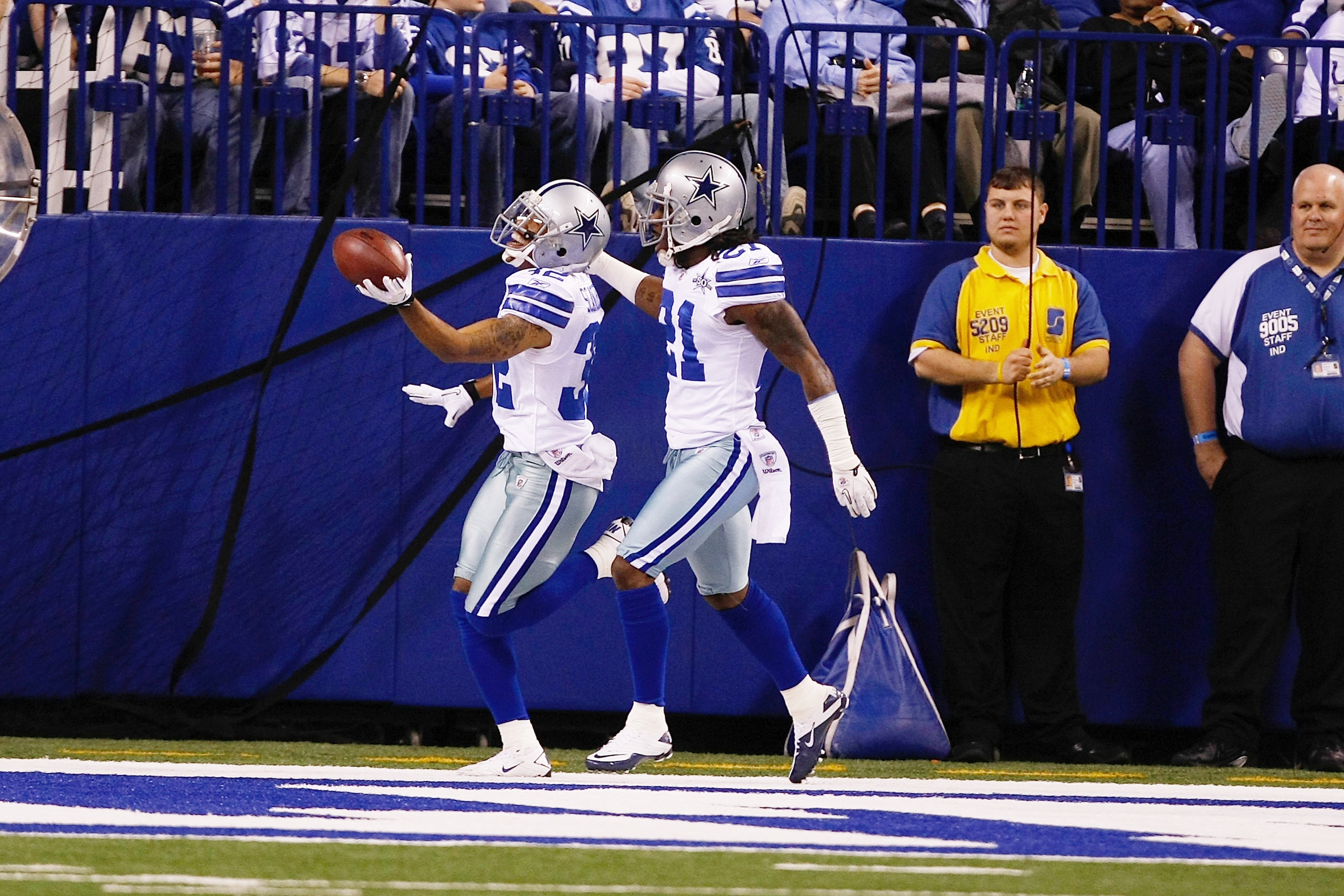 INDIANAPOLIS, IN - DECEMBER 05: Orlando Scandrick #32 of the Dallas Cowboys celebrates with Mike Jenkins after scoring a touchdown after an interception against the Indianapolis Colts at Lucas Oil Stadium on December 5, 2010 in Indianapolis, Indiana.  (Ph
