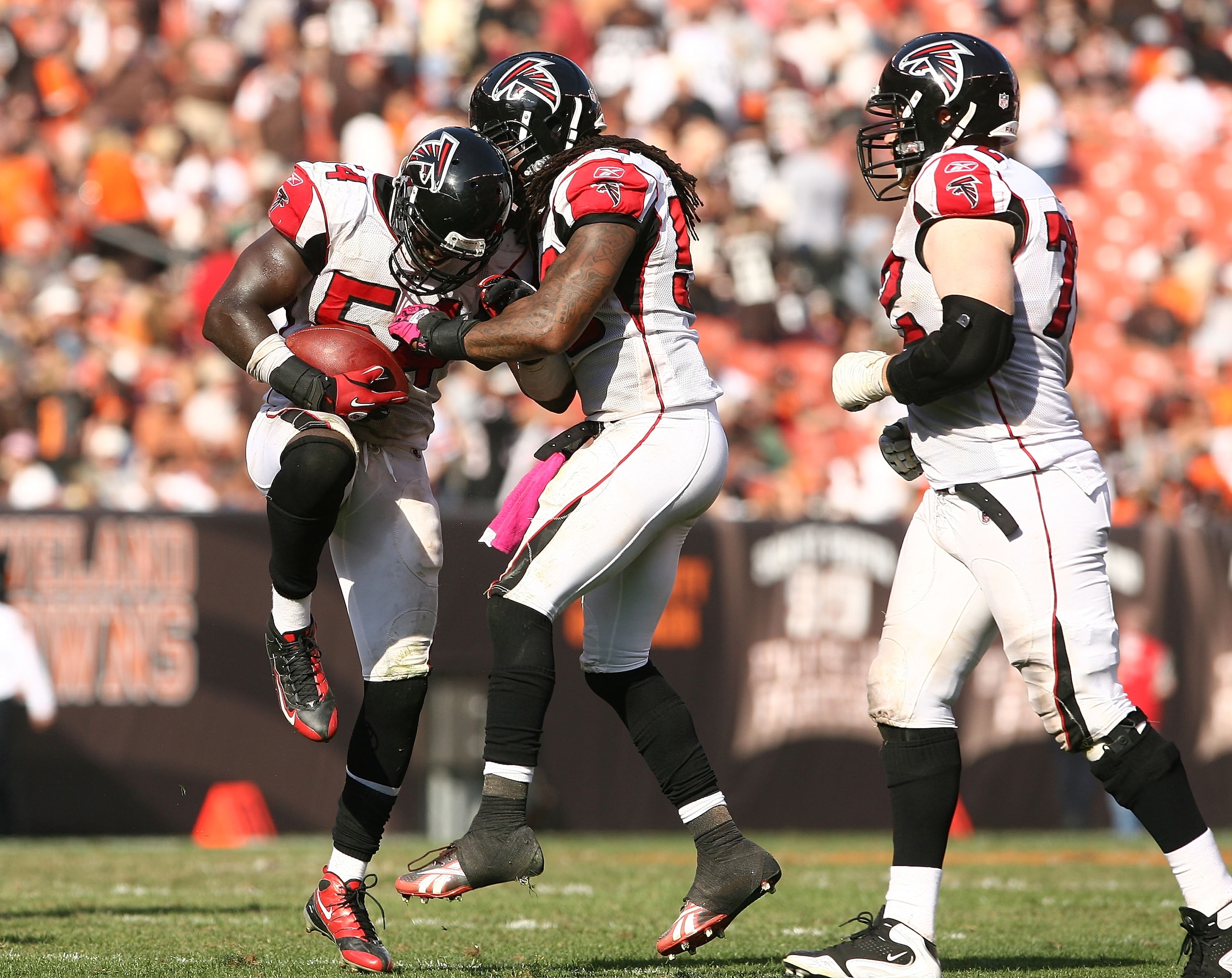 CLEVELAND - OCTOBER 10:  Linebacker Stephen Nicholas #54 (L) of the Atlanta Falcons celebrates with Curtis Lofton #50 and Sam Baker #72 after intercepting the ball against  the Cleveland Browns at Cleveland Browns Stadium on October 10, 2010 in Cleveland,
