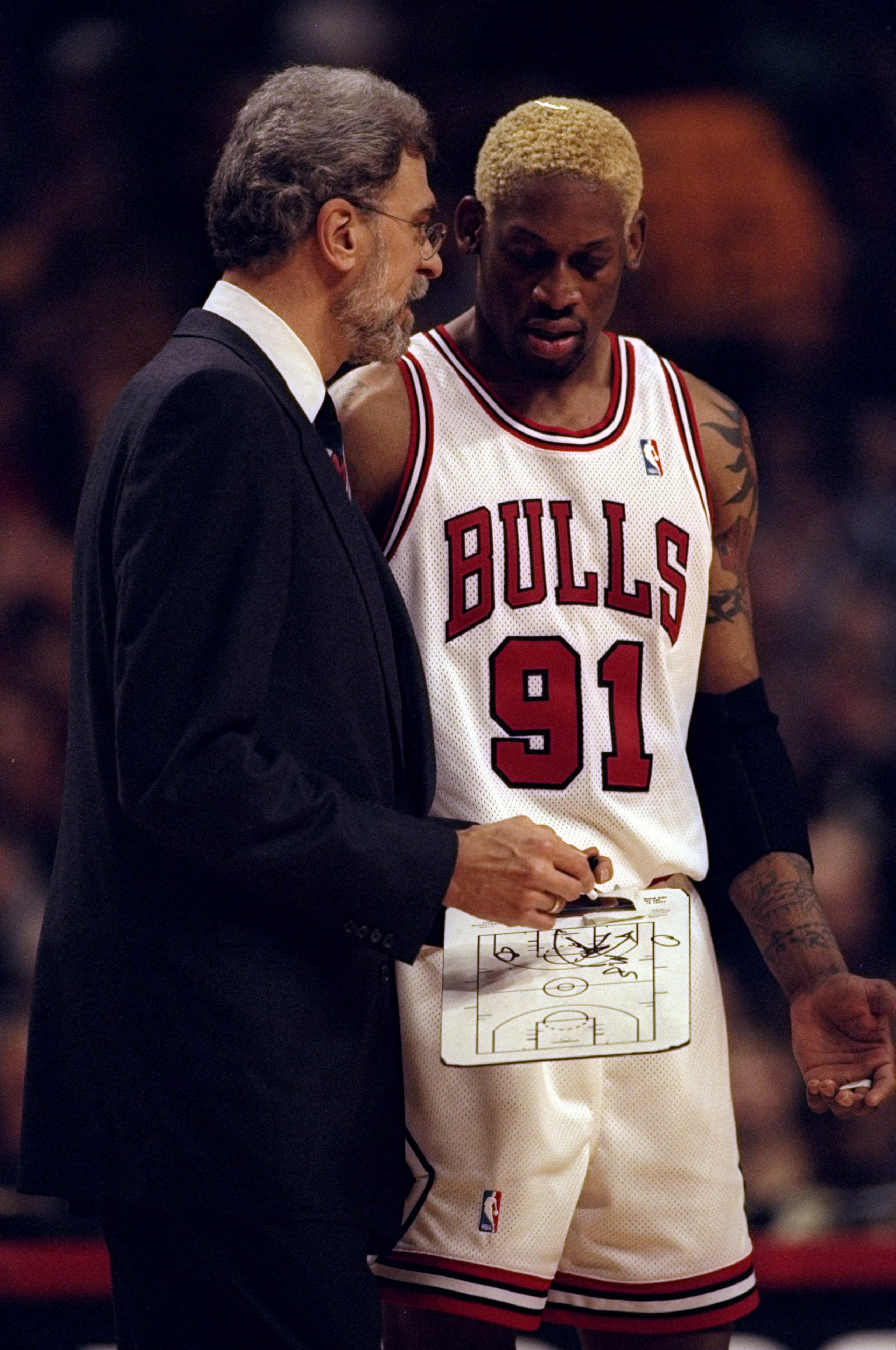 3 May 1998: Dennis Rodman #91 talks with Phil Jackson of the Chicago Bulls during the NBA Playoffs round 1 game against the Charlotte Hornets at the United Center in Chicago, Illinois. The Bulls defeated the Hornets 83-70.