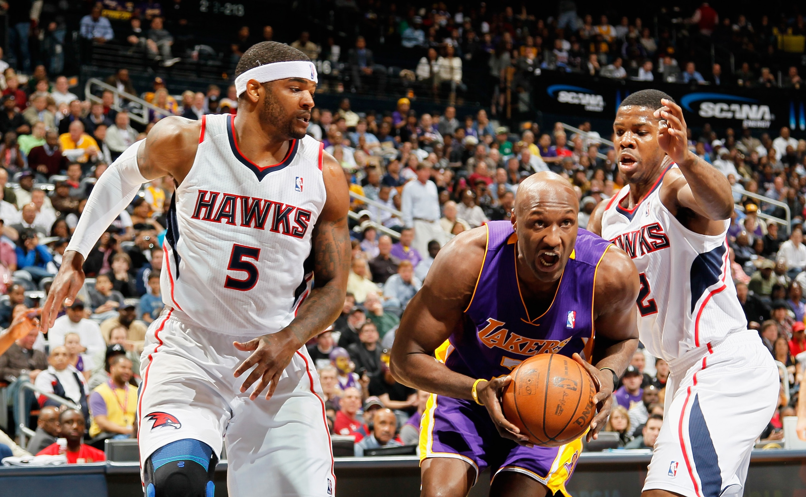 ATLANTA, GA - MARCH 08:  Lamar Odom #7 of the Los Angeles Lakers drives between Josh Smith #5 and Joe Johnson #2 of the Atlanta Hawks at Philips Arena on March 8, 2011 in Atlanta, Georgia.  NOTE TO USER: User expressly acknowledges and agrees that, by dow