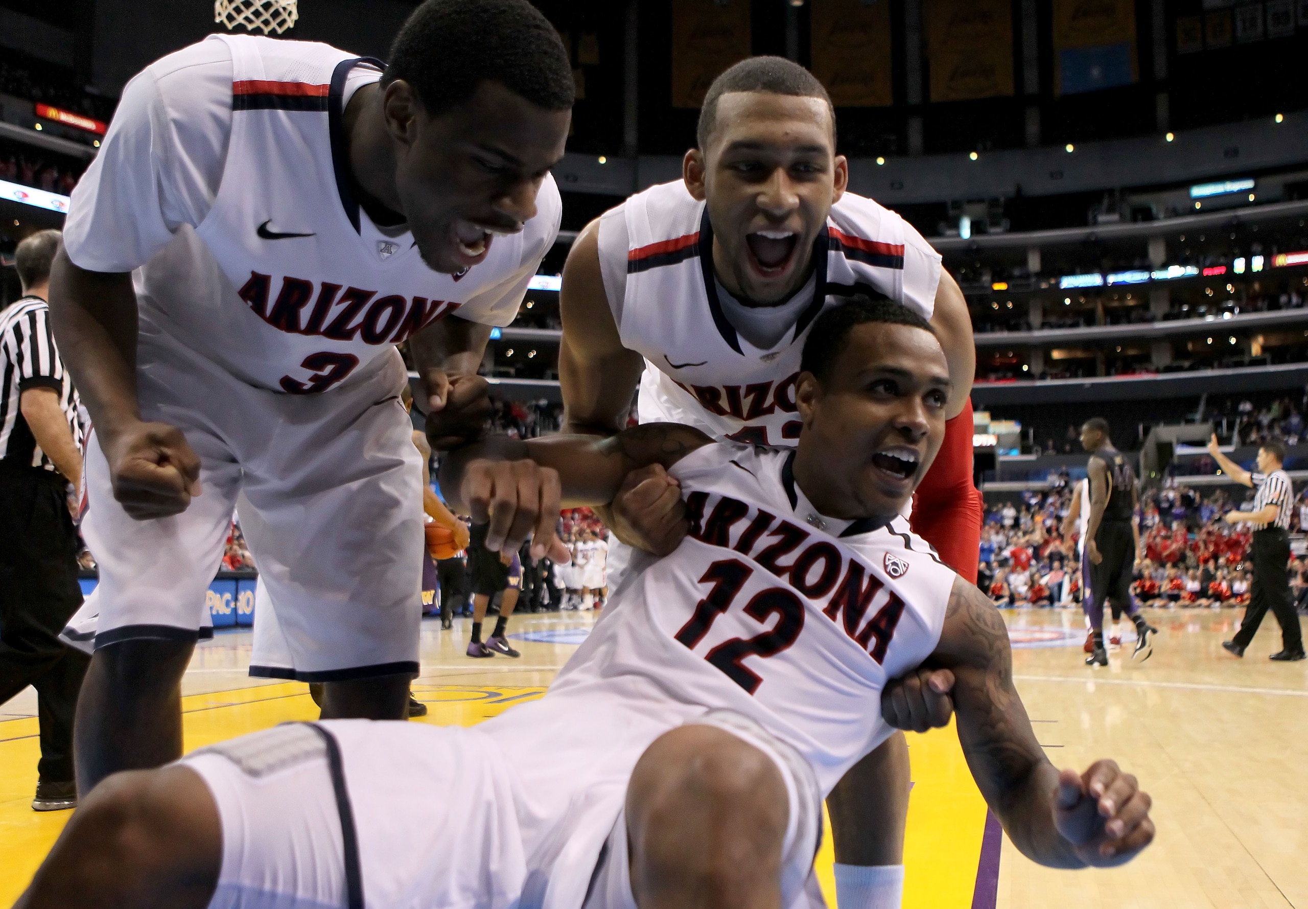 LOS ANGELES, CA - MARCH 12:  Kevin Parrom #3, Jamelle Horne #42 and Lamont Jones #12 of the Arizona Wildcats react after Jones takes a charge in the second half while taking on the Washington Huskies in the championship game of the 2011 Pacific Life Pac-1