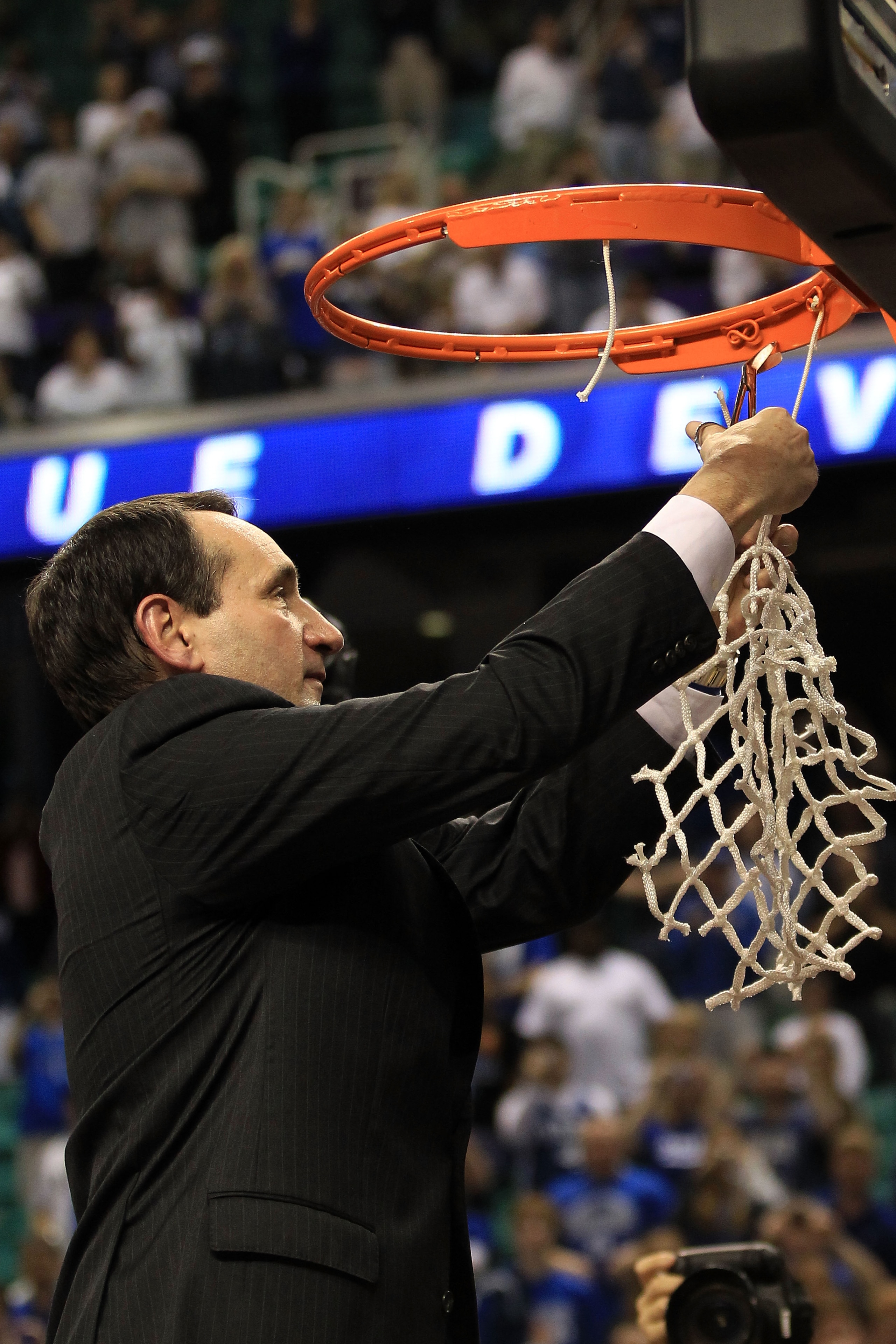 GREENSBORO, NC - MARCH 13:  Head coach Mike Krzyzewski of the Duke Blue Devils cuts down the net after defeating the North Carolina Tar Heels 75-58 in the championship game of the 2011 ACC men's basketball tournament at the Greensboro Coliseum on March 13