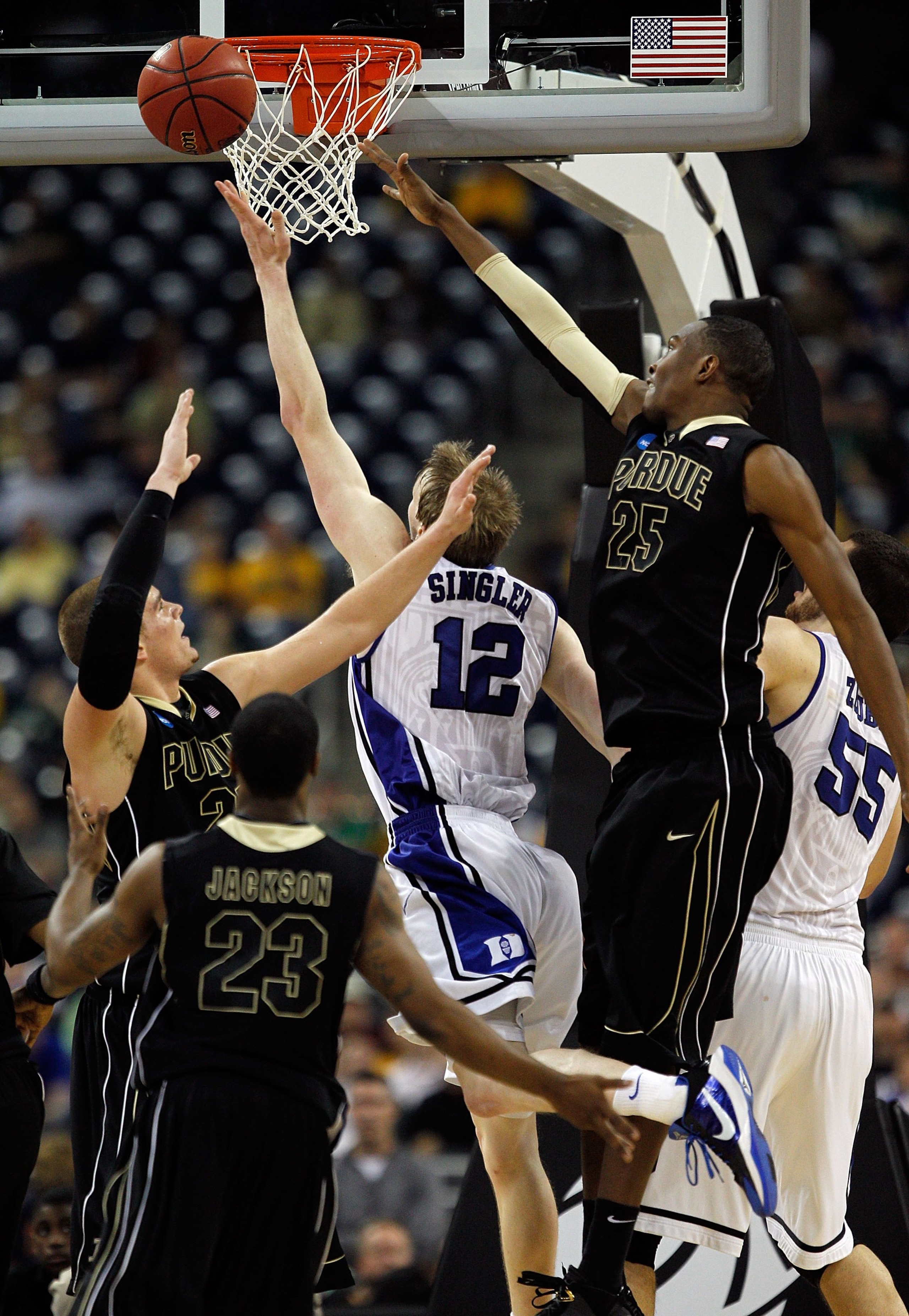 HOUSTON - MARCH 26: Kyle Singler #12 of the Duke Blue Devils puts up a shot against Lewis Jackson #23, D.J. Byrd #21 and JaJuan Johnson #25 of the Purdue Boilermakers during the south regional semifinal of the 2010 NCAA men's basketball tournament at Reli