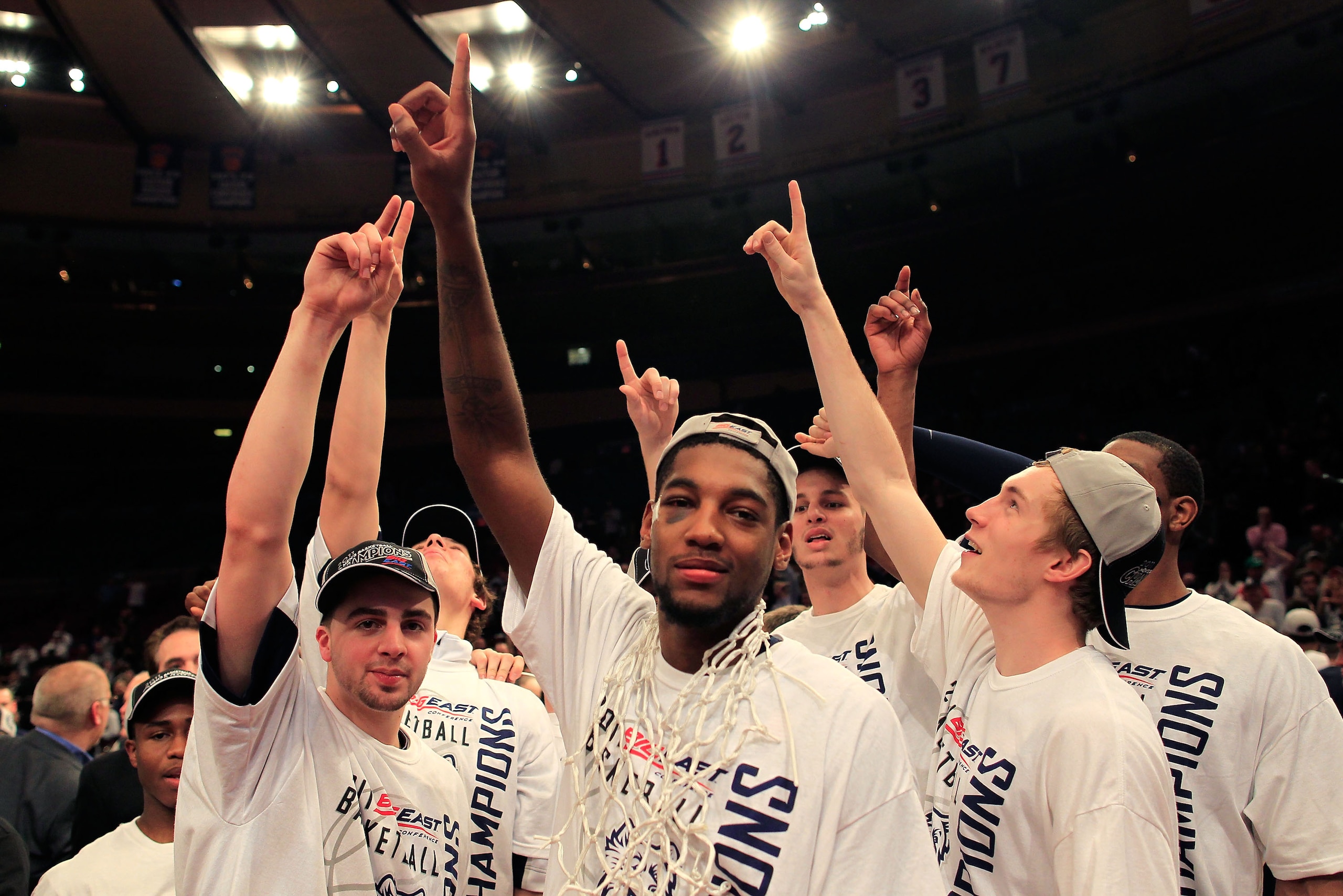 NEW YORK, NY - MARCH 12: Roscoe Smith #22 of the Connecticut Huskies (C) celebrates with teammates after defeating the Louisville Cardinals during the championship of the 2011 Big East Men's Basketball Tournament presented by American Eagle Outfitters at NEW YORK, NY - MARCH 12: Roscoe Smith #22 of the Connecticut Huskies (C) celebrates with teammates after defeating the Louisville Cardinals during the championship of the 2011 Big East Men's Basketball Tournament presented by American Eagle Outfitters at