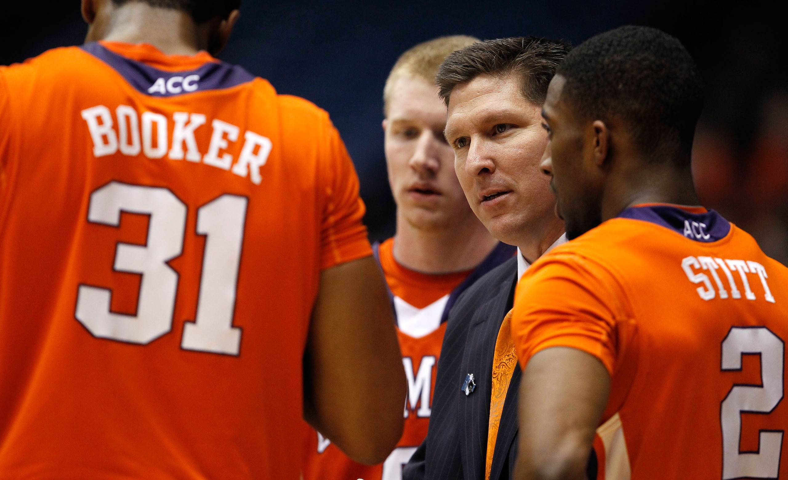 DAYTON, OH - MARCH 15: head coach Brad Brownell of the Clemson Tigers speaks to his players Devin Booker #31, Tanner Smith #5 and Demontez Stitt #2 on the bench against the UAB Blazers during the first round of the 2011 NCAA men's basketball tournament at