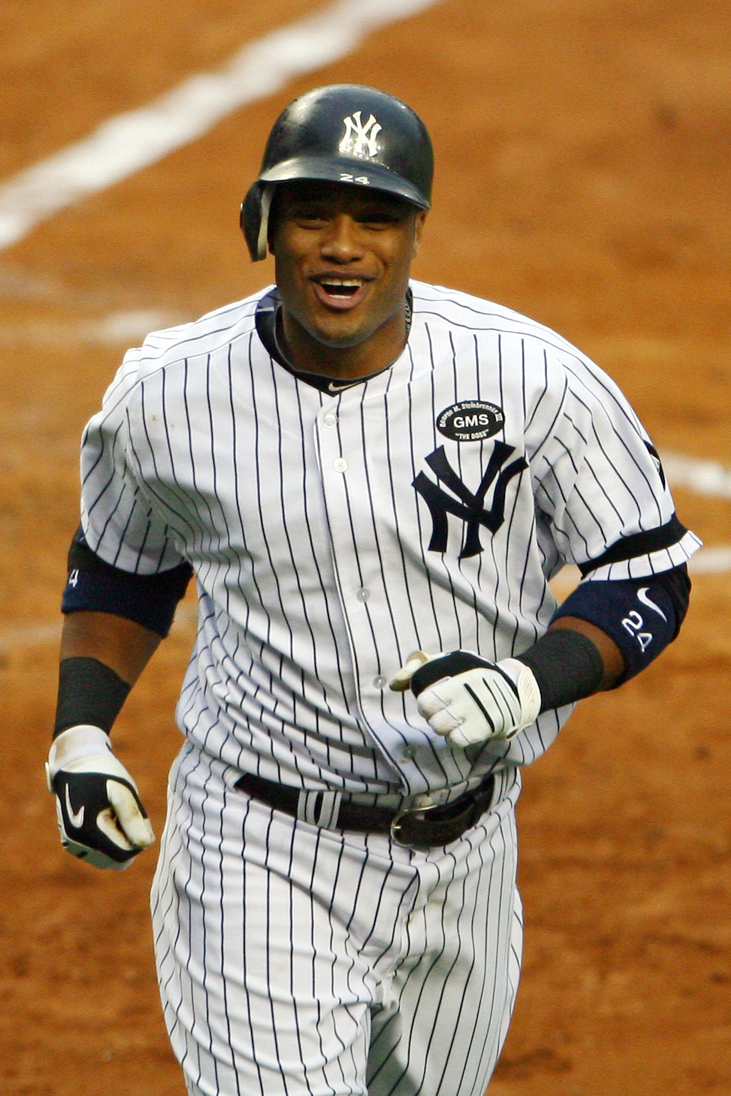 NEW YORK - OCTOBER 20:  Robinson Cano #24 of the New York Yankees reacts after he scored on his solo home run in the bottom of the third inning against the Texas Rangers in Game Five of the ALCS during the 2010 MLB Playoffs at Yankee Stadium on October 20