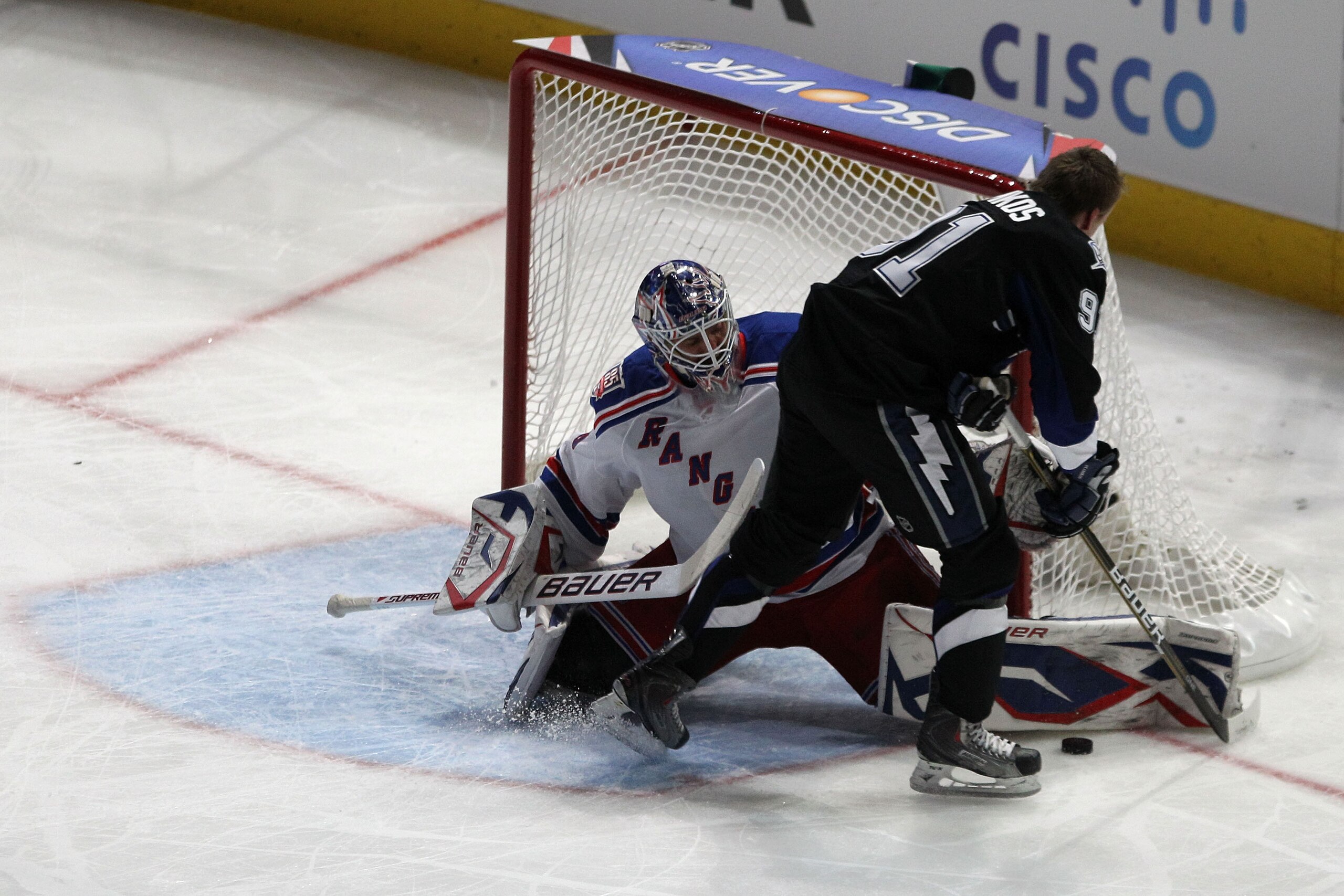 RALEIGH, NC - JANUARY 29:  Steven Stamkos #91 of the Tampa Bay Lightning shoots against Henrik Lundqvist #30 of New York Rangers during the elimination shootout part of the Honda NHL SuperSkills competition part of 2011 NHL All-Star Weekend at the RBC Cen