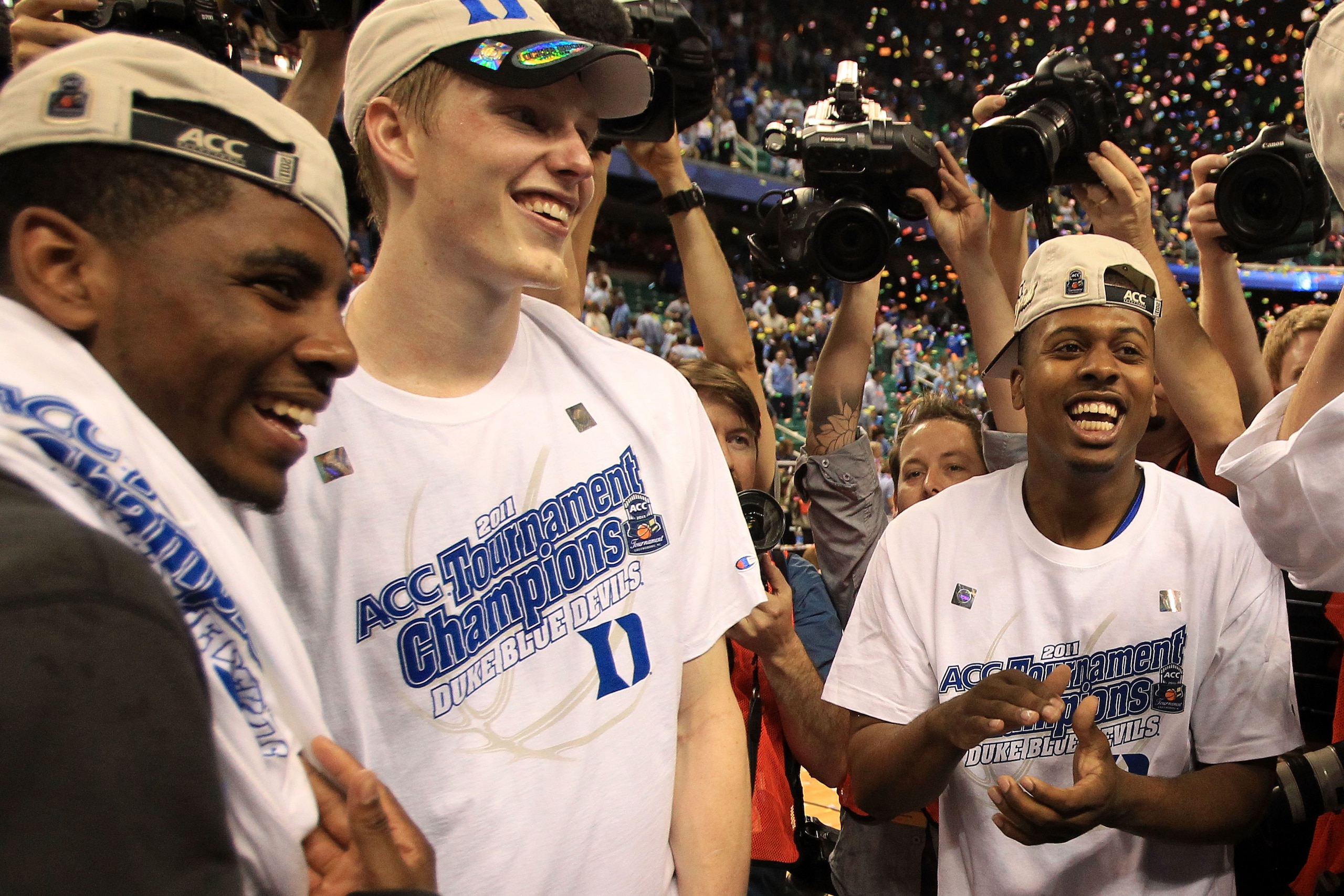 GREENSBORO, NC - MARCH 13:  Kyrie Irving #1, Kyle Singler #12 and Tyler Thornton #3 of the Duke Blue Devils celebrate their 75-58 victory over the North Carolina Tar Heels in the championship game of the 2011 ACC men's basketball tournament at the Greensb