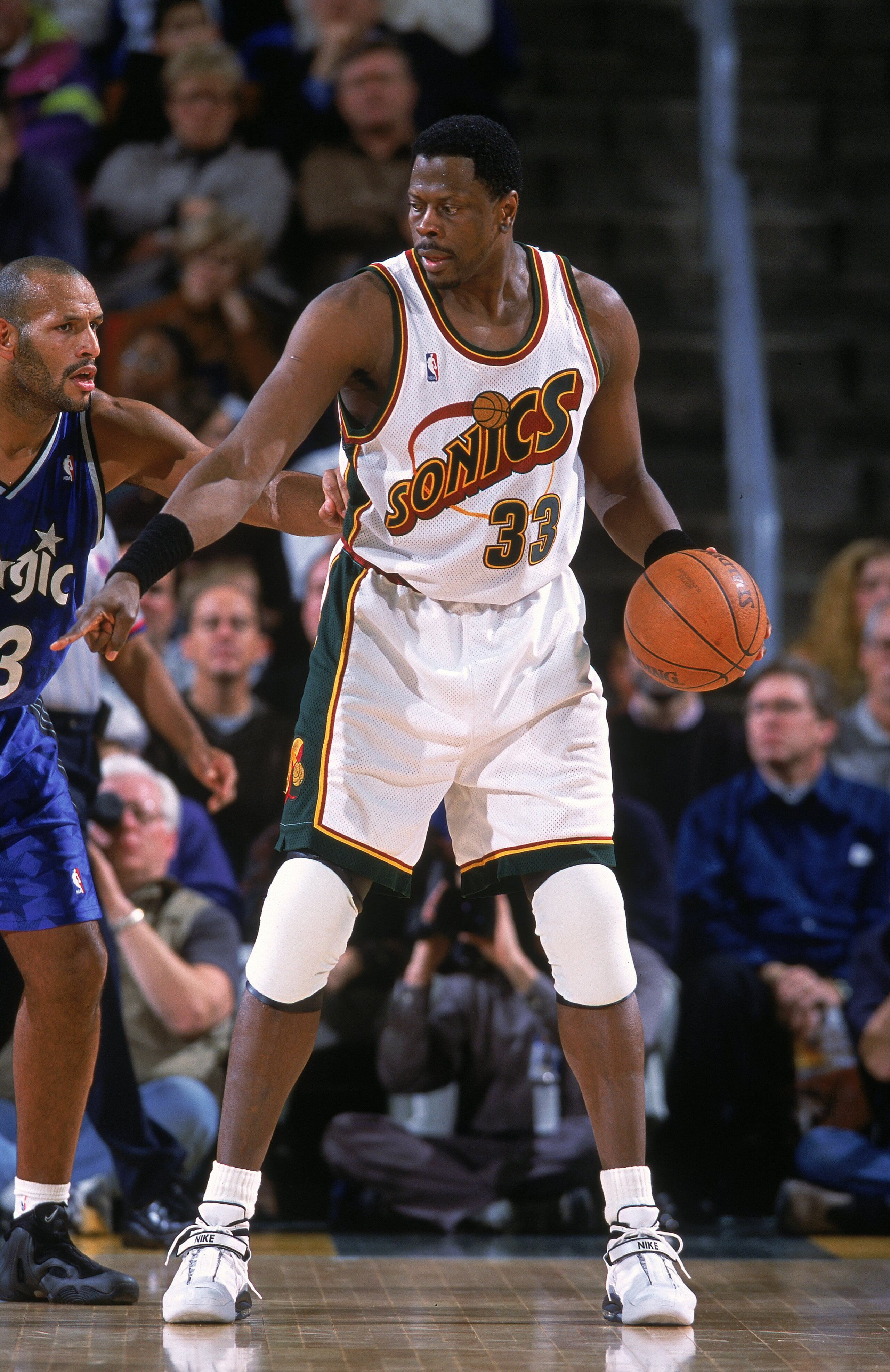 12 Dec 2000:  Patrick Ewing #33 of the Seattle SuperSonics dribbles the ball as John Amaechi #13 of the Orlando Magic gaurds him during the game at the Key Arena in Seattle, Washington.  The SuperSonics defeated the Magic 97-92.    NOTE TO USER: It is exp