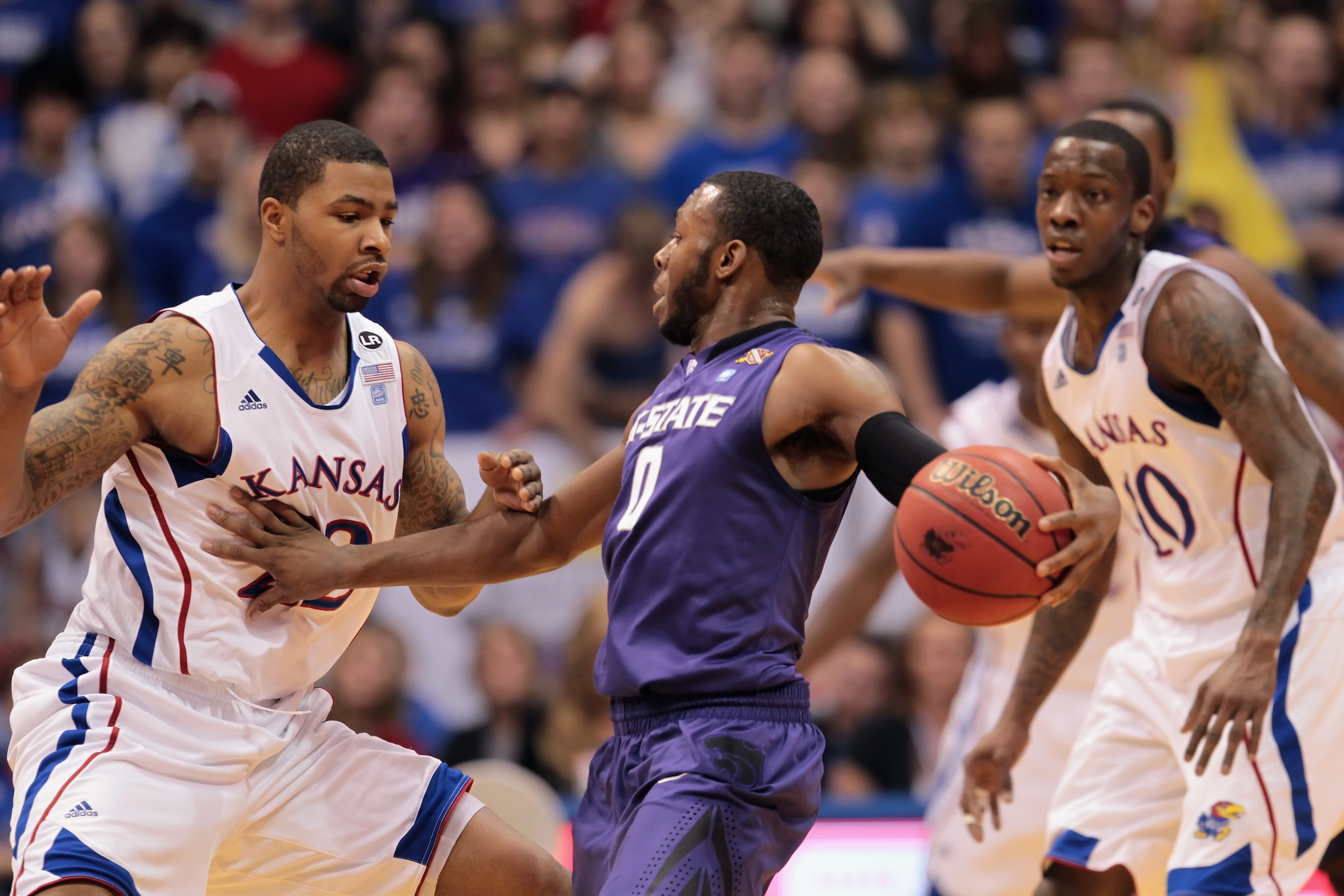 LAWRENCE, KS - JANUARY 29:  Jacob Pullen #0 of the Kansas State Wildcats controls the ball as Marcus Morris #22 of the Kansas Jayhawks defends during the game on January 29, 2011 at Allen Fieldhouse in Lawrence, Kansas.  (Photo by Jamie Squire/Getty Image