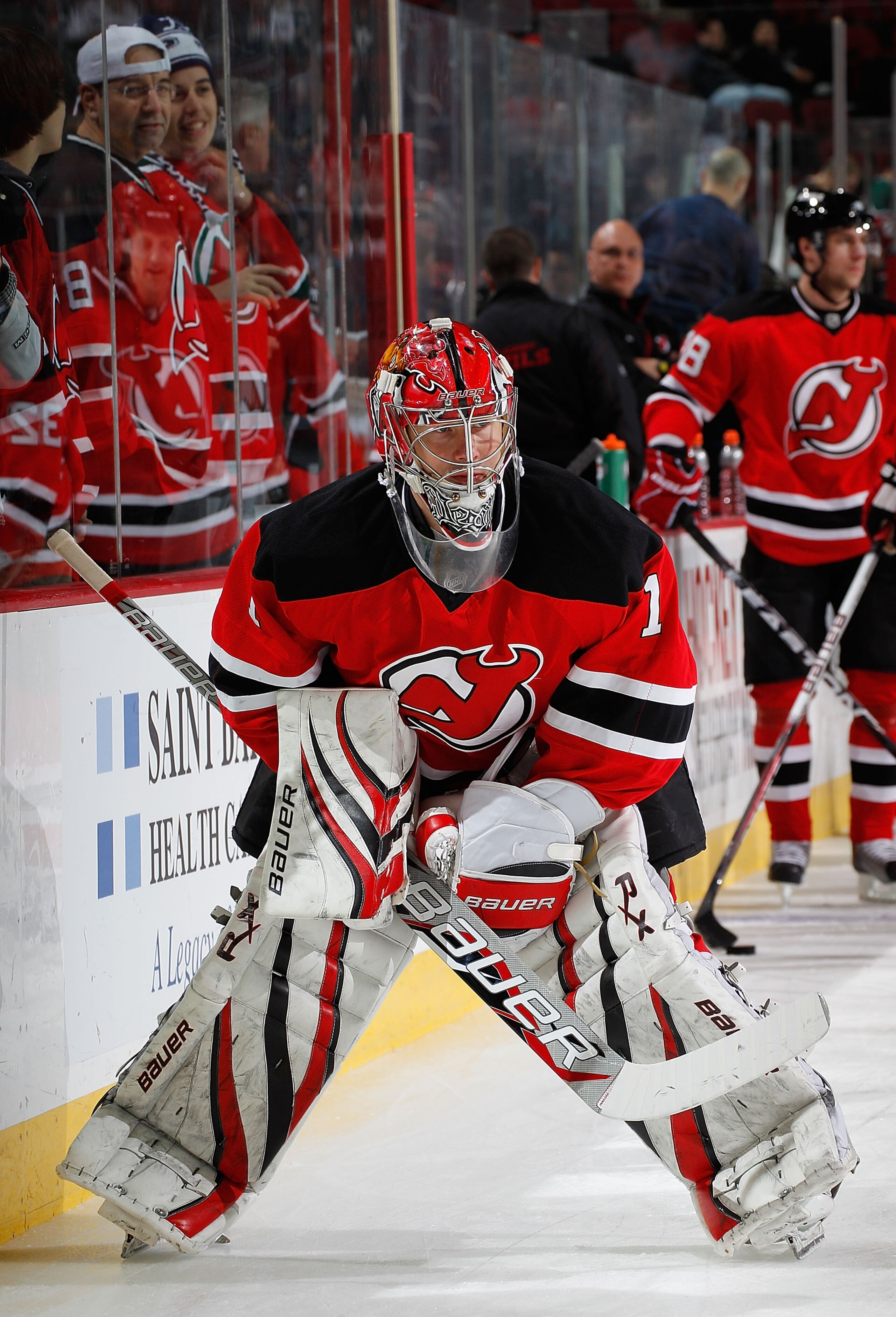 NEWARK, NJ - MARCH 02:  Goalie Johan Hedberg #1 of the New Jersey Devils skates past fans during warmups before an NHL hockey game against the Tampa Bay Lightning at the Prudential Center on March 2, 2011 in Newark, New Jersey.  (Photo by Paul Bereswill/G