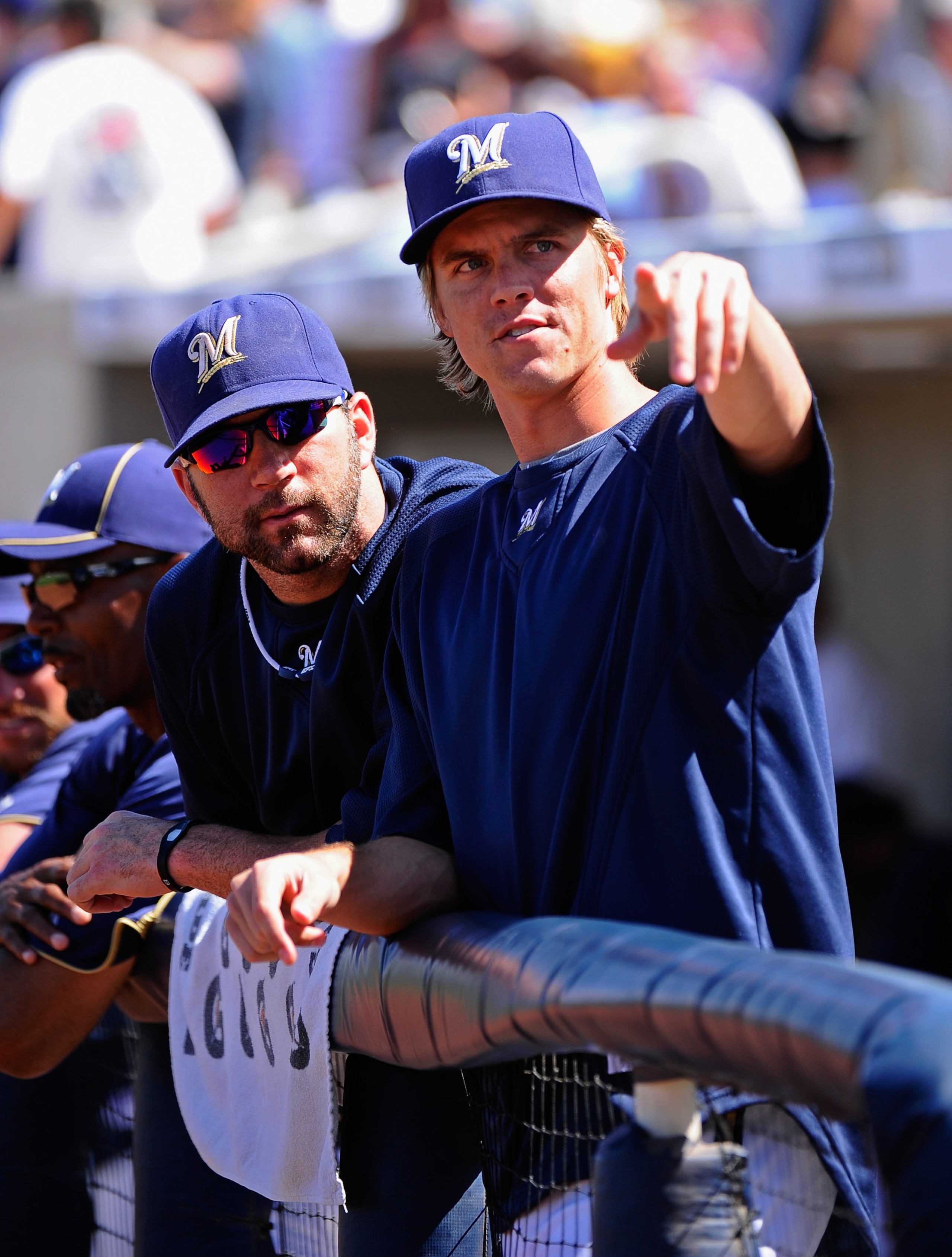 PHOENIX, AZ - MARCH 10:  Pitchers Zack Greinke #13 and Shaun Marcum #18  of the Milwaukee Brewers look at fans during the spring teaining baseball agme against Colorado Rockies at Maryvale Baseball Park on March 10, 2011 in Phoenix, Arizona.  (Photo by Ke