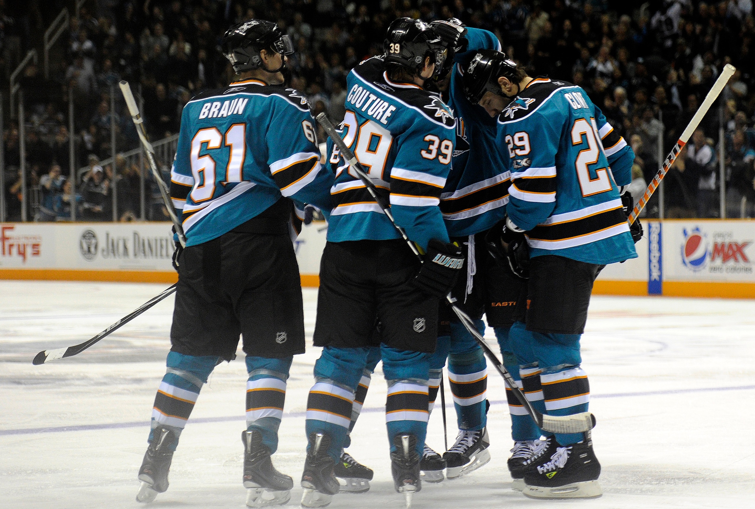 SAN JOSE, CA - MARCH 8: Dany Heatley #15 of the San Jose Sharks is surounded by teammates Logan Couture #39, Ryane Clowe #29, and Justin Braun #61 after he gets an assist on a goal against the Nashville Predators in the second period of an NHL hockey game