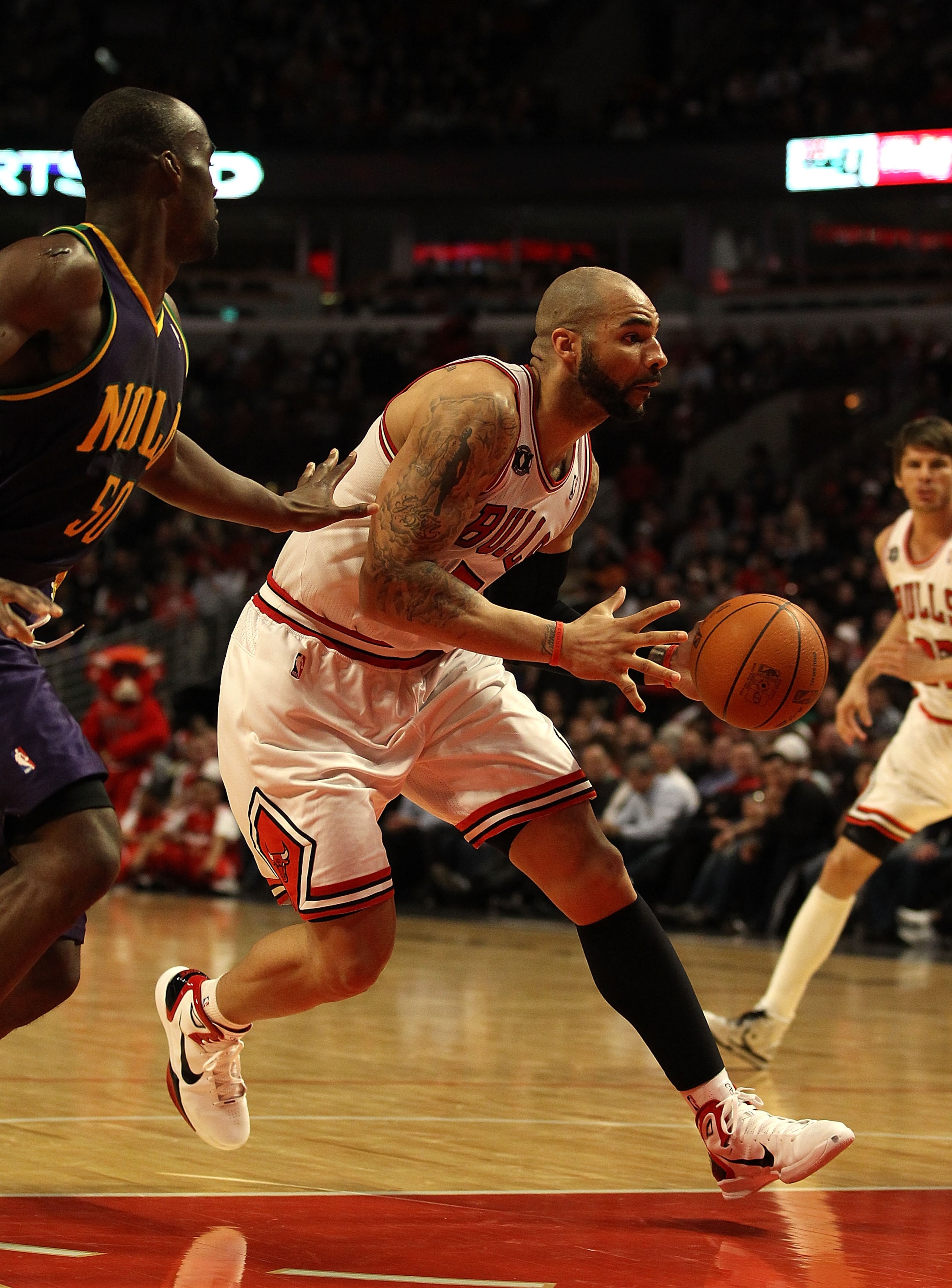 CHICAGO, IL - MARCH 07: Carlos Boozer #5 of the Chicago Bulls drives past Emeka Okafor #50 of the New Orleans Hornets at the United Center on March 7, 2011 in Chicago, Illinois. The Bulls defeated the Hornets 85-77. NOTE TO USER: User expressly acknowledg CHICAGO, IL - MARCH 07: Carlos Boozer #5 of the Chicago Bulls drives past Emeka Okafor #50 of the New Orleans Hornets at the United Center on March 7, 2011 in Chicago, Illinois. The Bulls defeated the Hornets 85-77. NOTE TO USER: User expressly acknowledg