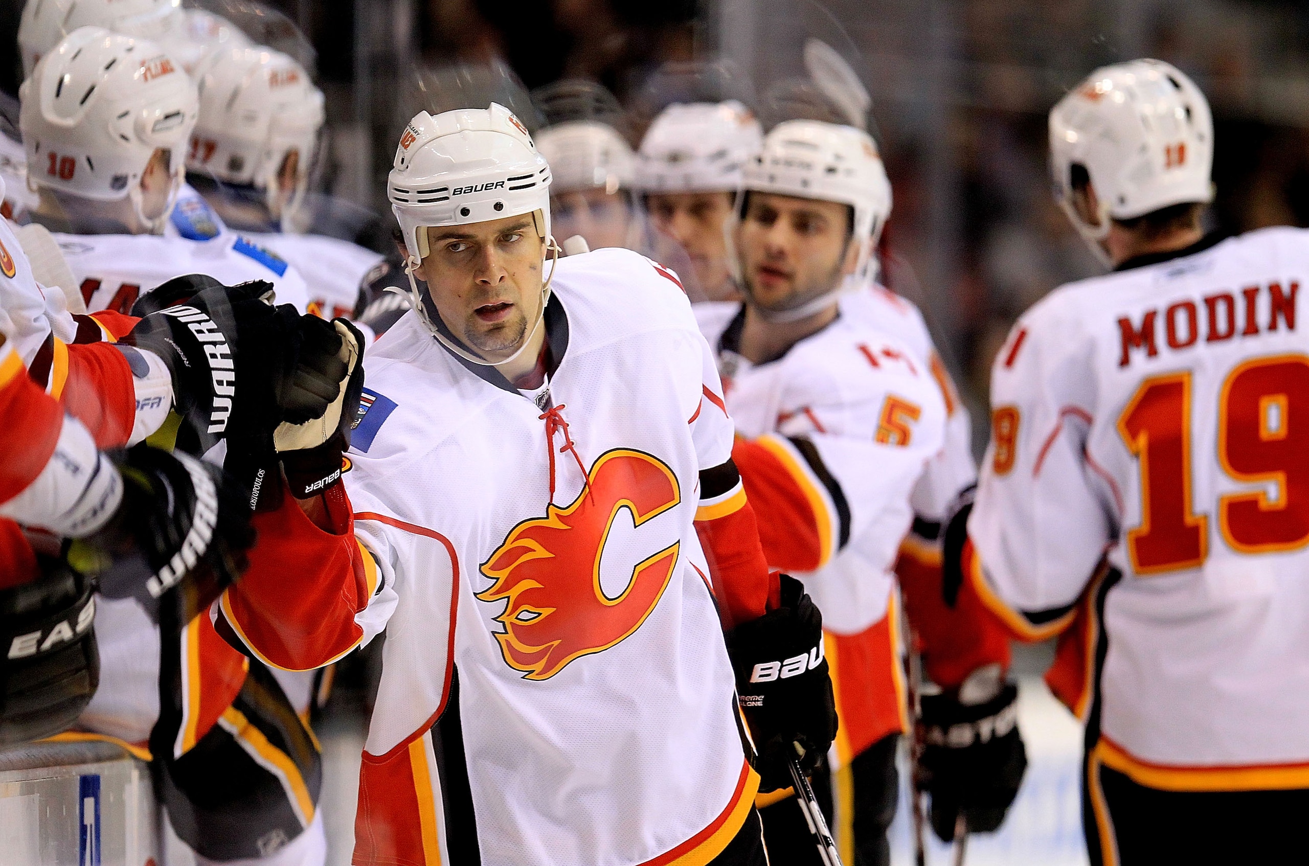DALLAS, TX - MARCH 09:  Right wing Tom Kostopoulos #16 of the Calgary Flames celebrates a goal against the Dallas Stars at American Airlines Center on March 9, 2011 in Dallas, Texas.  (Photo by Ronald Martinez/Getty Images)