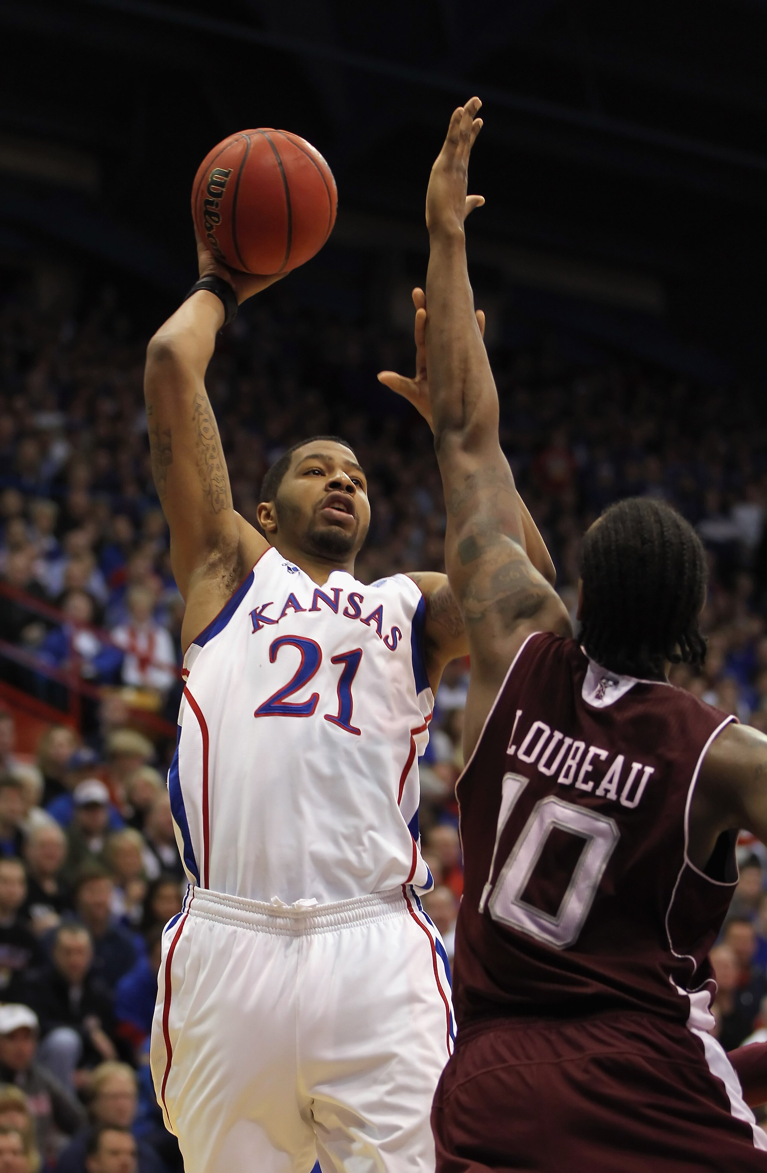 LAWRENCE, KS - MARCH 02:  Markieff Morris #21 of the Kansas Jayhawks shoots over David Loubeau #10 of the Texas A&M Aggies during the game on March 2, 2011 at Allen Fieldhouse in Lawrence, Kansas.  (Photo by Jamie Squire/Getty Images)