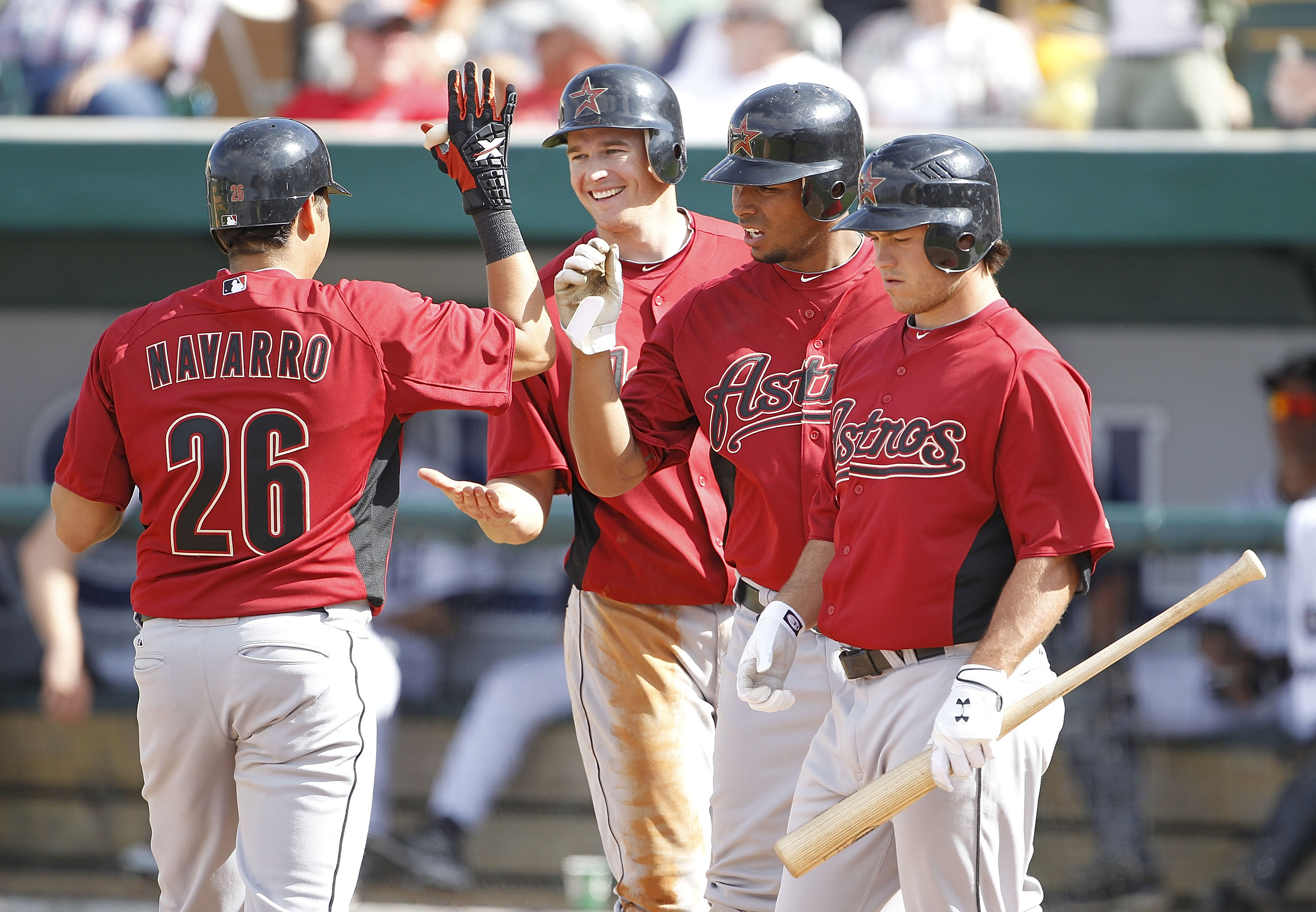 LAKELAND, FL - MARCH 02: Oswaldo Navarro #26 celebrates with his teammates T. J Steele #92 Angel Sanchez #36 and Koby Clemens #91 after hitting an eight inning three run home run  during the game against the Detroit Tigers at Joker Marchant Stadium on Mar
