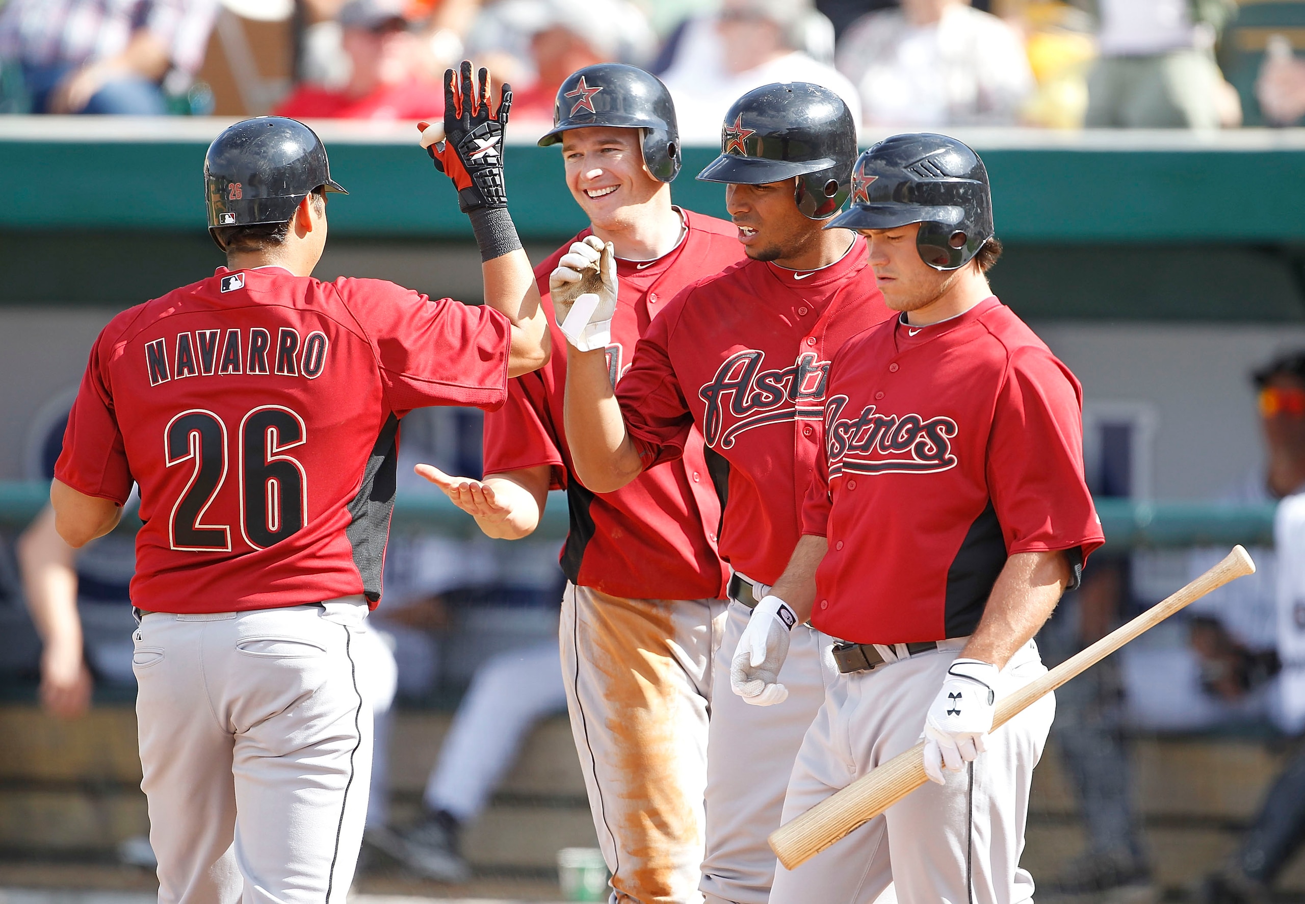 LAKELAND, FL - MARCH 02: Oswaldo Navarro #26 celebrates with his teammates T. J Steele #92 Angel Sanchez #36 and Koby Clemens #91 after hitting an eight inning three run home run  during the game against the Detroit Tigers at Joker Marchant Stadium on Mar