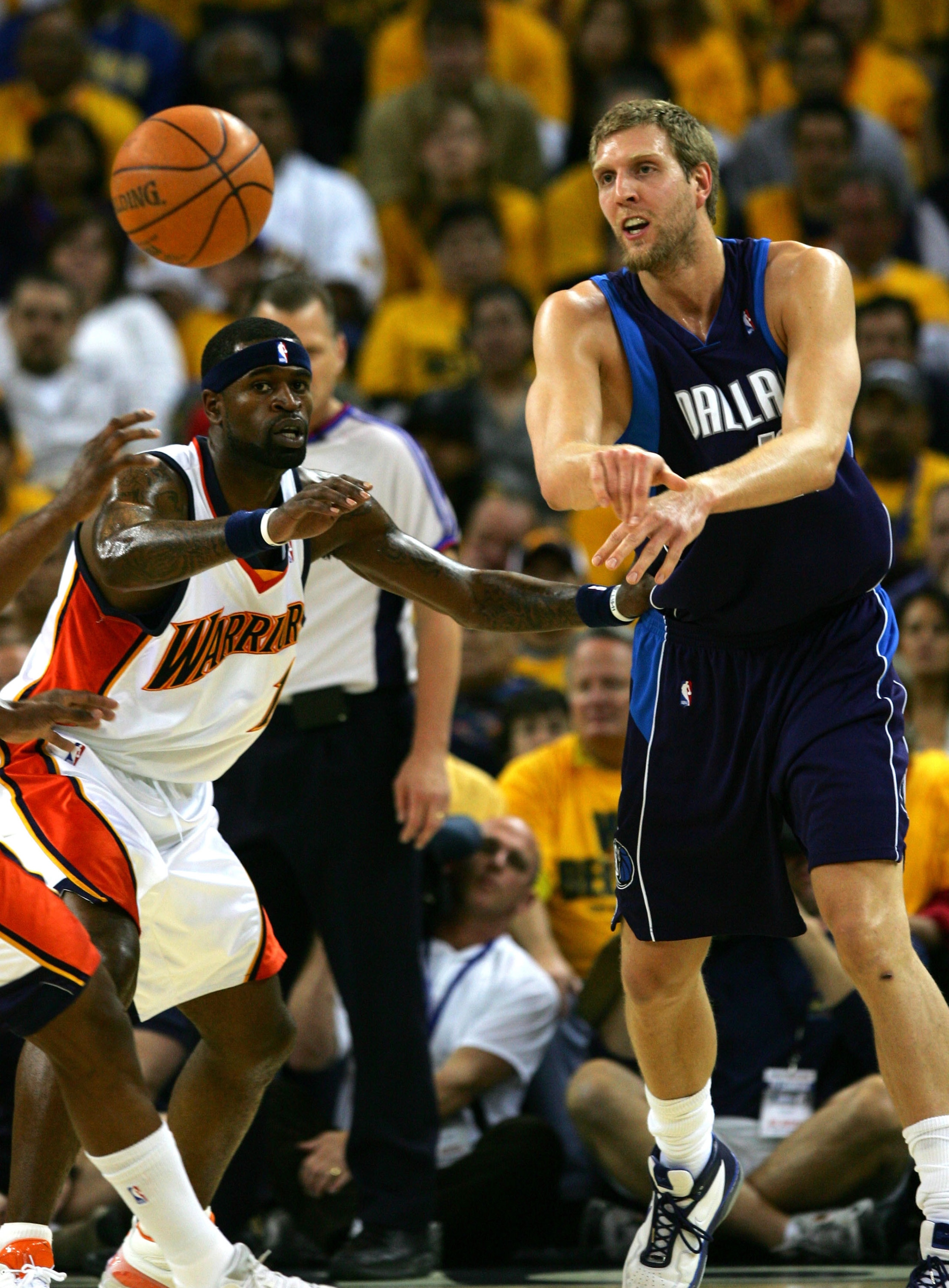 OAKLAND, CA - MAY 03: Dirk Nowitizki #41 of the Dallas Mavericks passes the ball against Stephen Jackson #1 of the Golden State Warriors in Game 6 of the Western Conference Quarterfinals during the 2007 NBA Playoffs on May 3, 2007 at Oracle Arena in Oakla